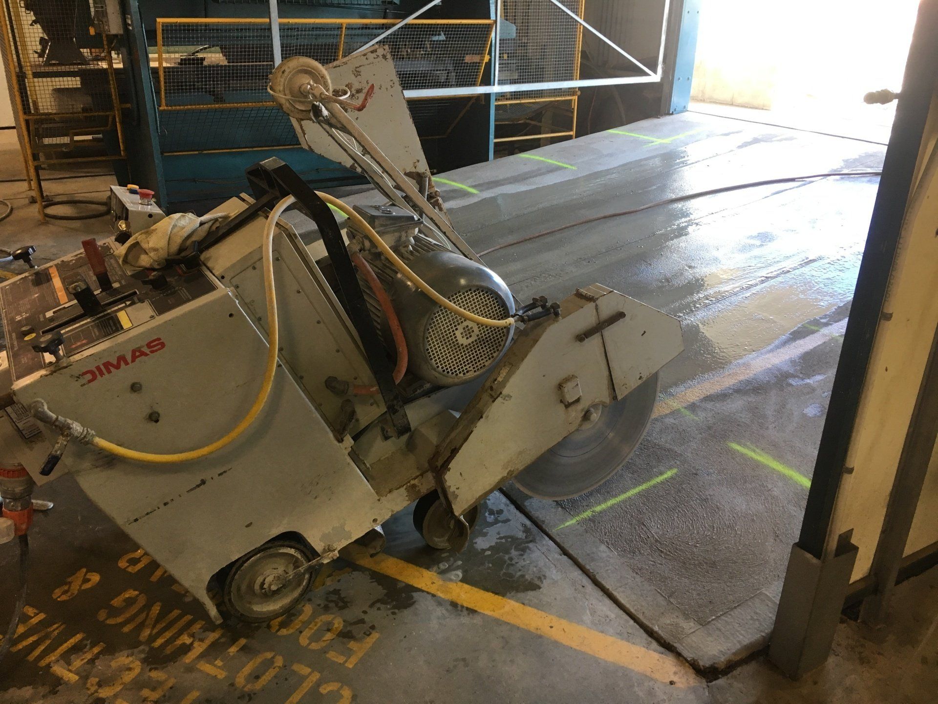 Construction Worker Grind The Concrete Surface — Concrete Cutters In Kempsey, NSW