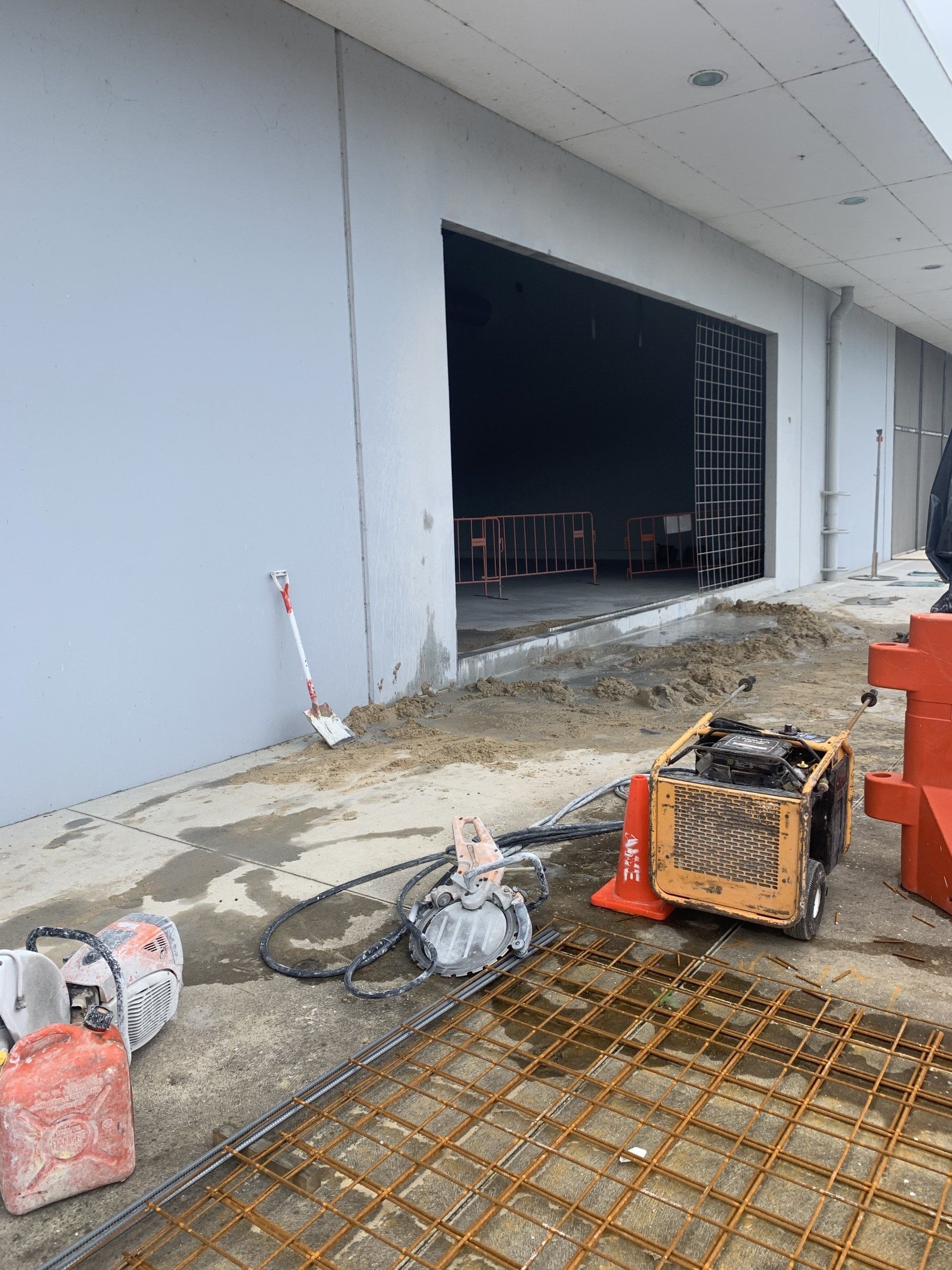 Construction Worker Cutting Asphalt Paving Stabs — Concrete Cutters In Port Macquarie, NSW