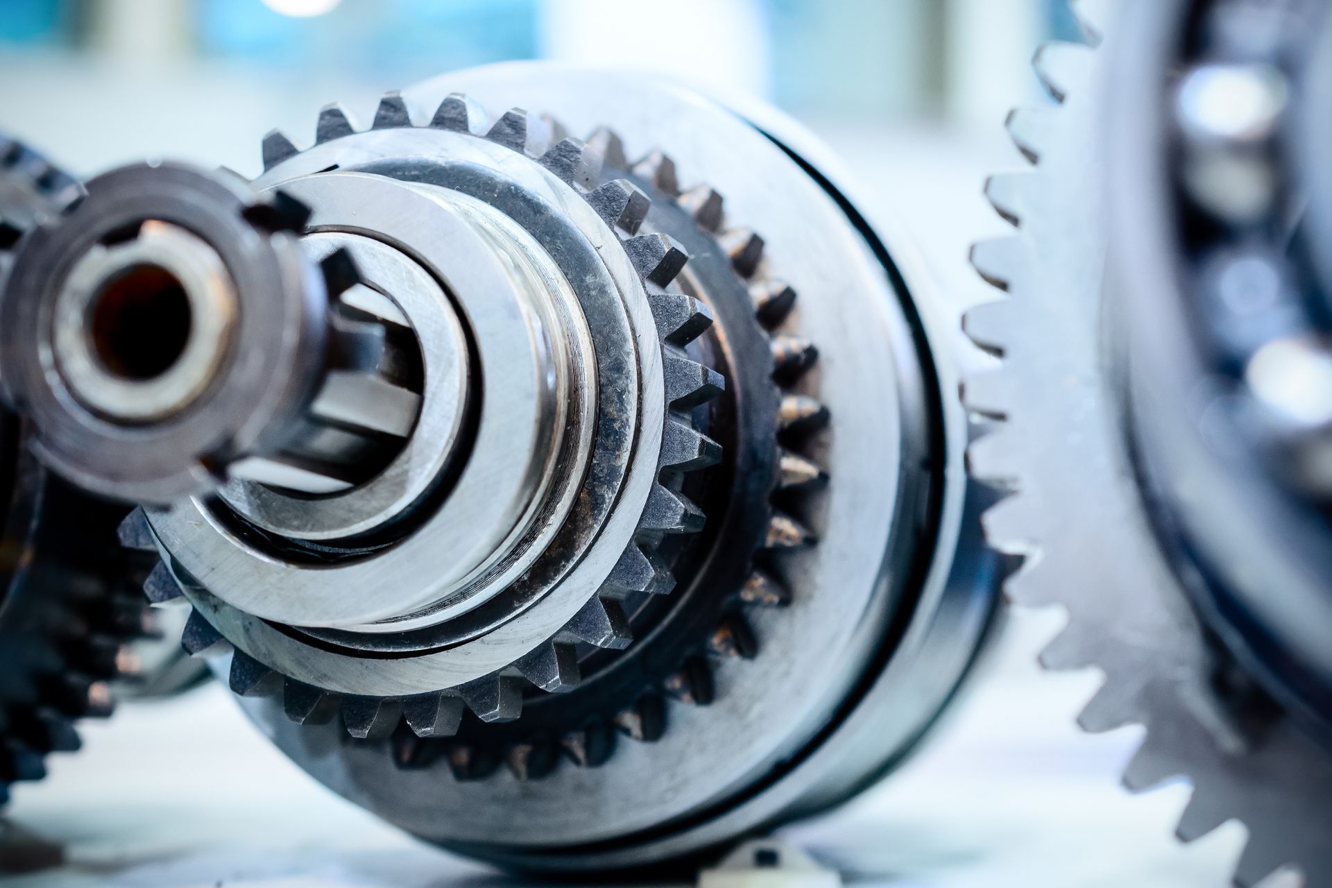 Precision metal shaft with gears and spline teeth for smooth power transfer.