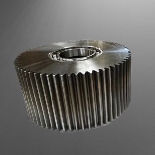 Large metal gear with teeth, cylindrical shape, and a central opening.