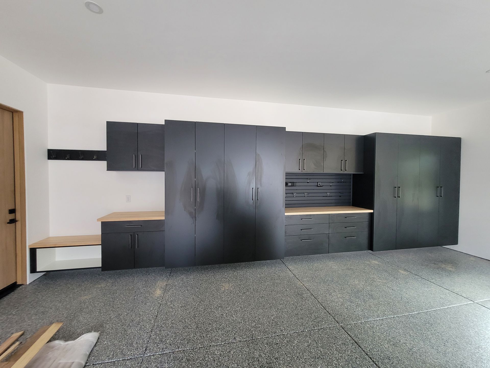 Empty modern room with dark cabinets and a speckled floor, viewed from the doorway