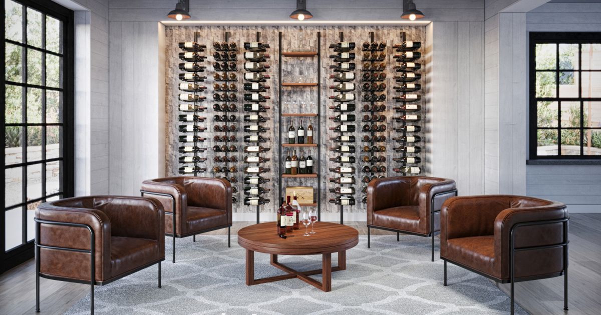 Modern wine cellar with leather chairs, round table, and wall-mounted wine racks in a bright room