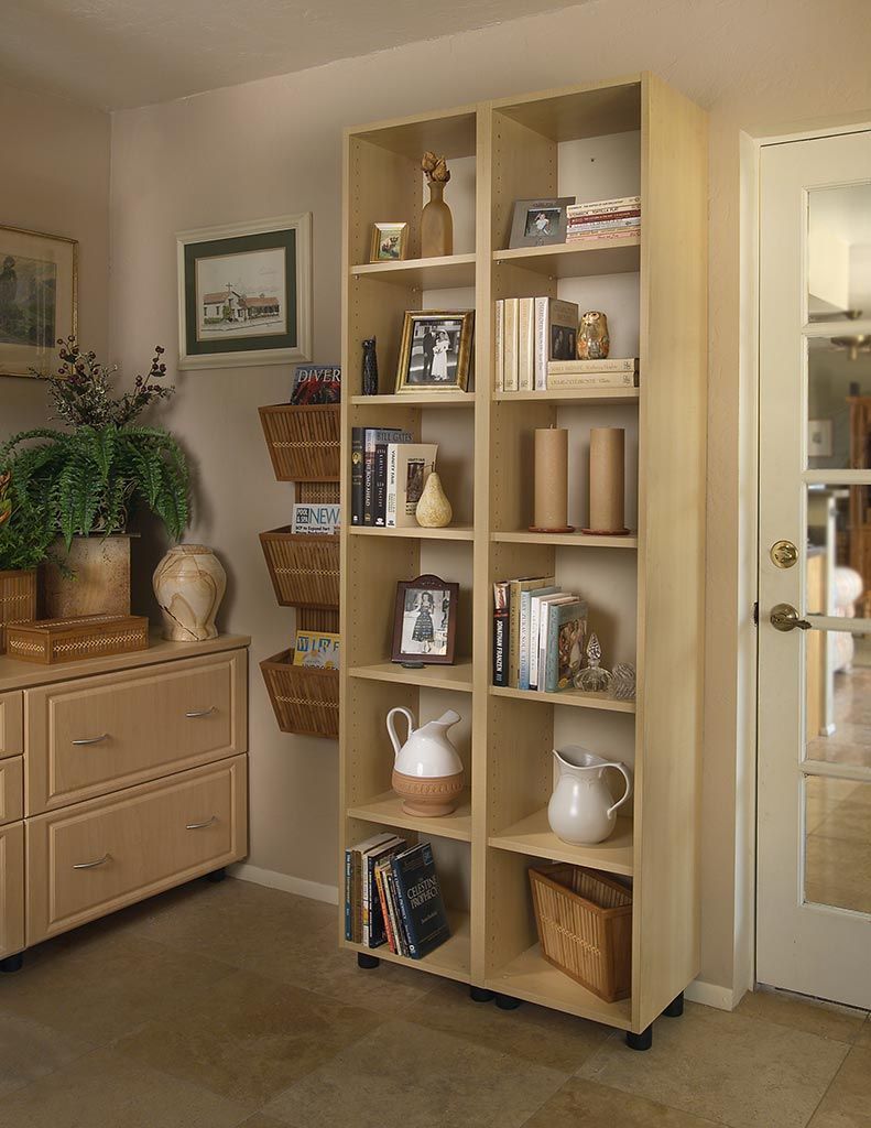 A bookshelf with a lot of books and pictures on it