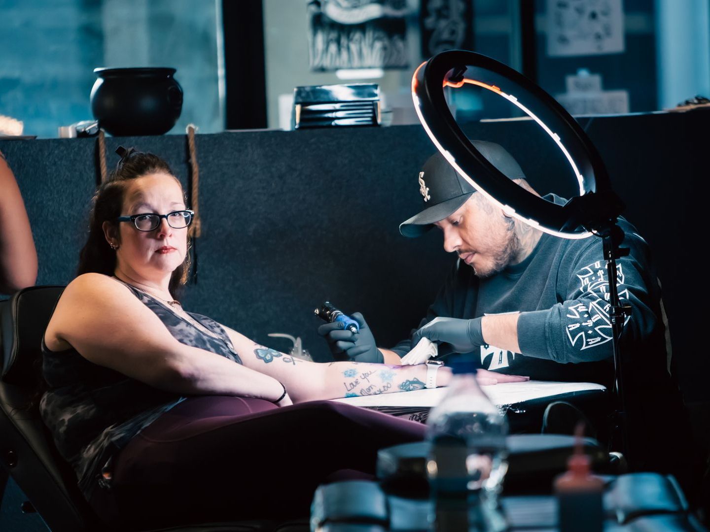 Alex working on a woman's wrist tattoo