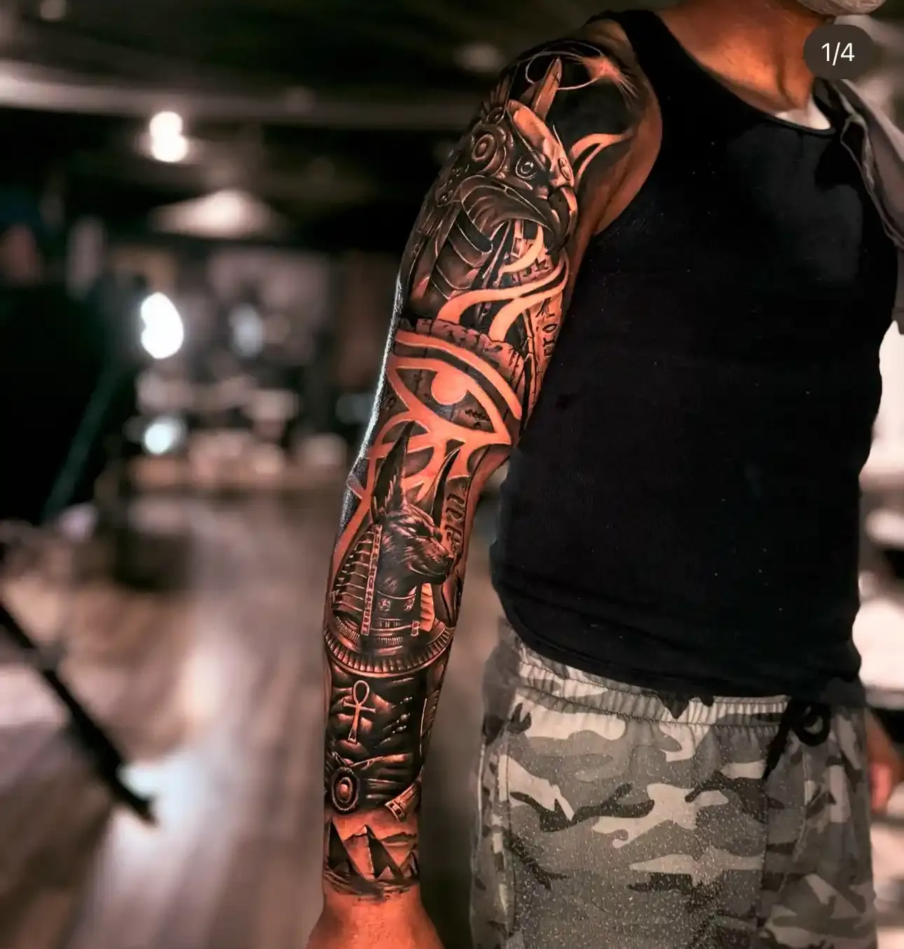 Black and grey Egyptian-themed sleeve tattoo on an arm