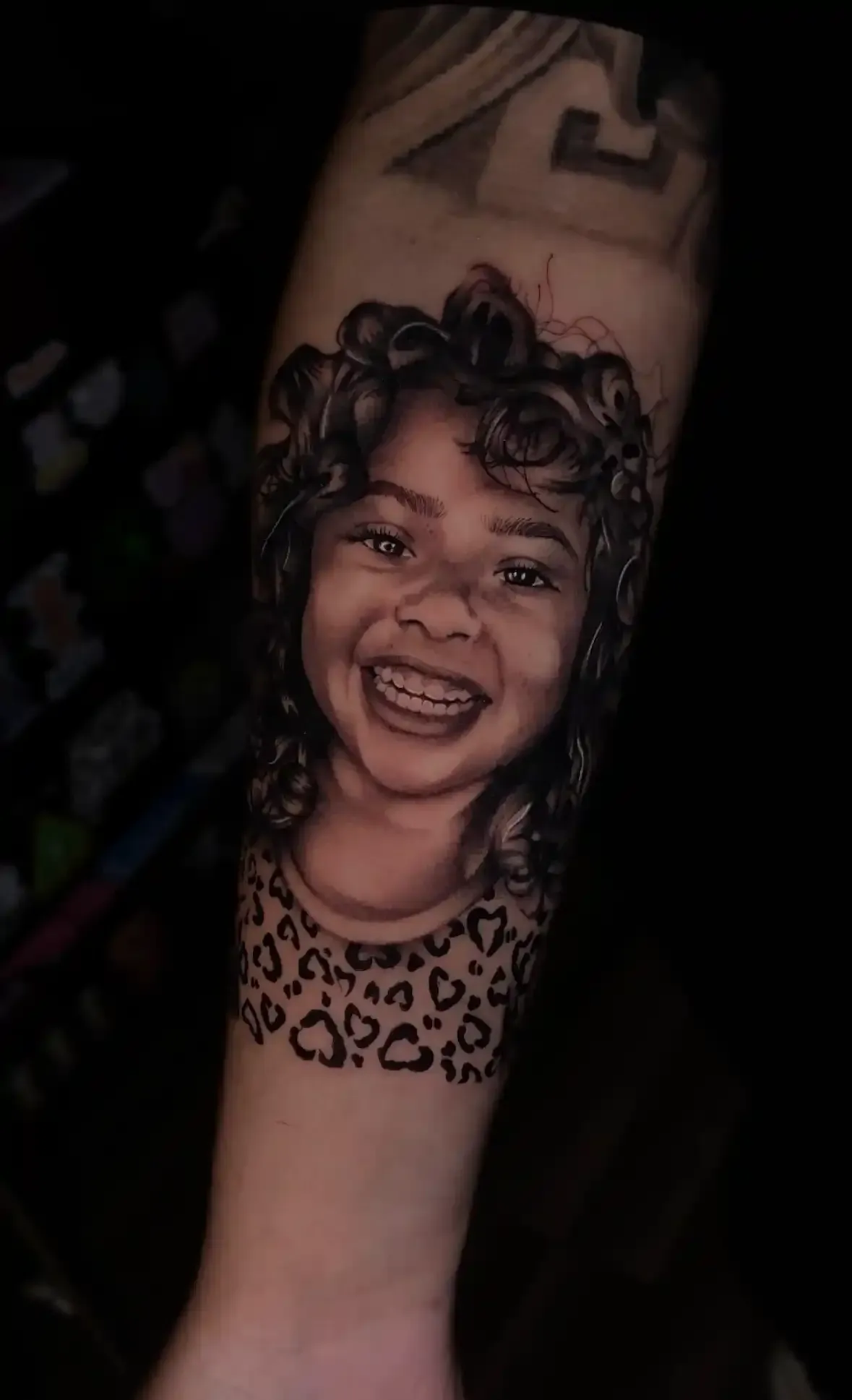black and white realism portrait of a smiling girl
