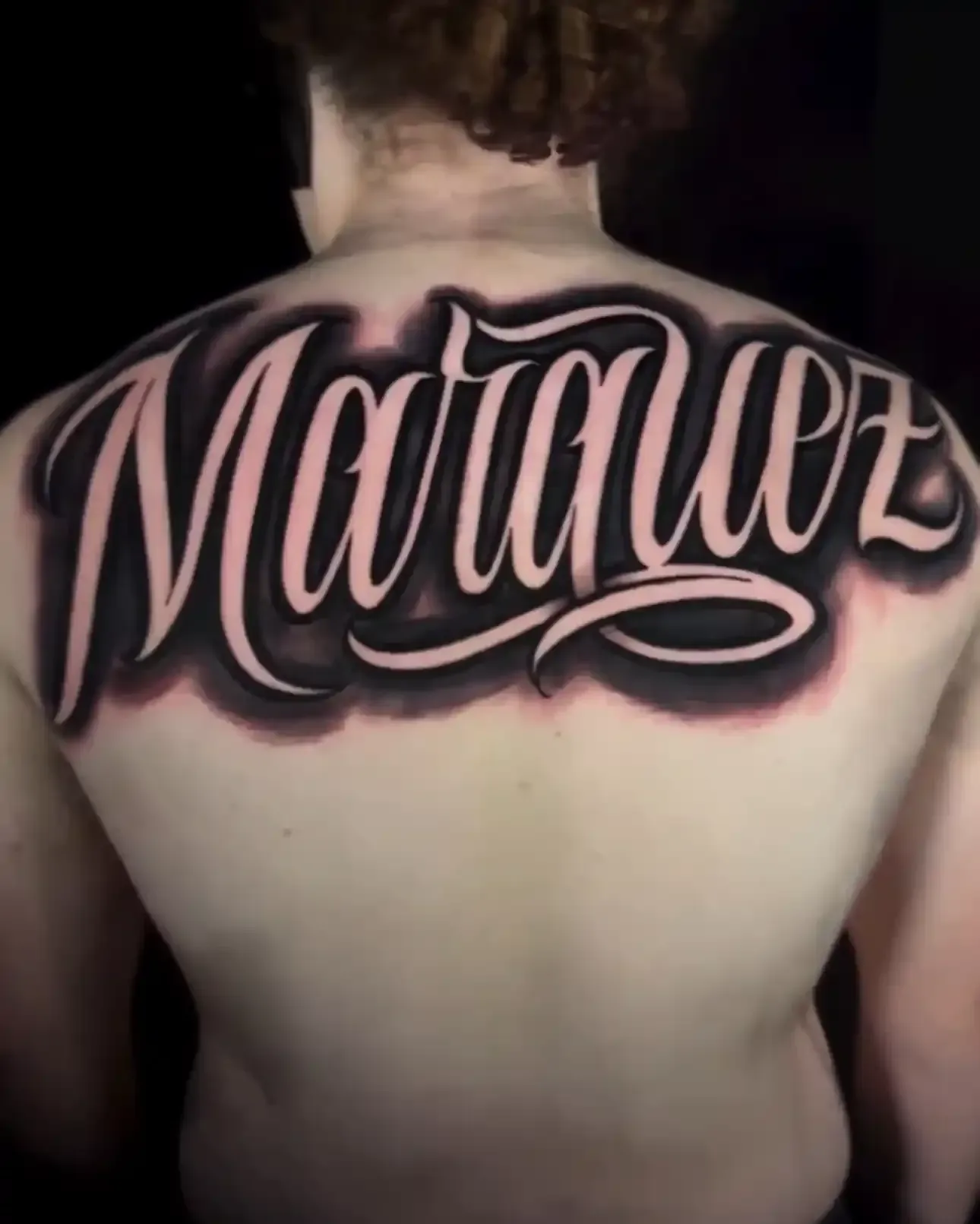 Script upper back tattoo by Gueroe 