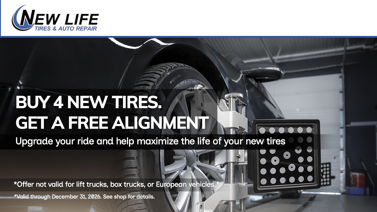 New Life Tire ad: buy 4 new tires, get a free alignment in a tire shop garage