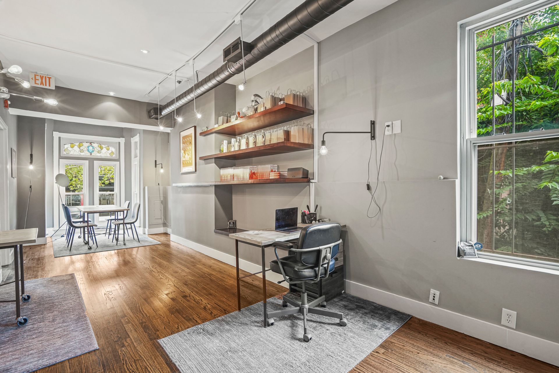 Private office with floating shelves and workspace desk