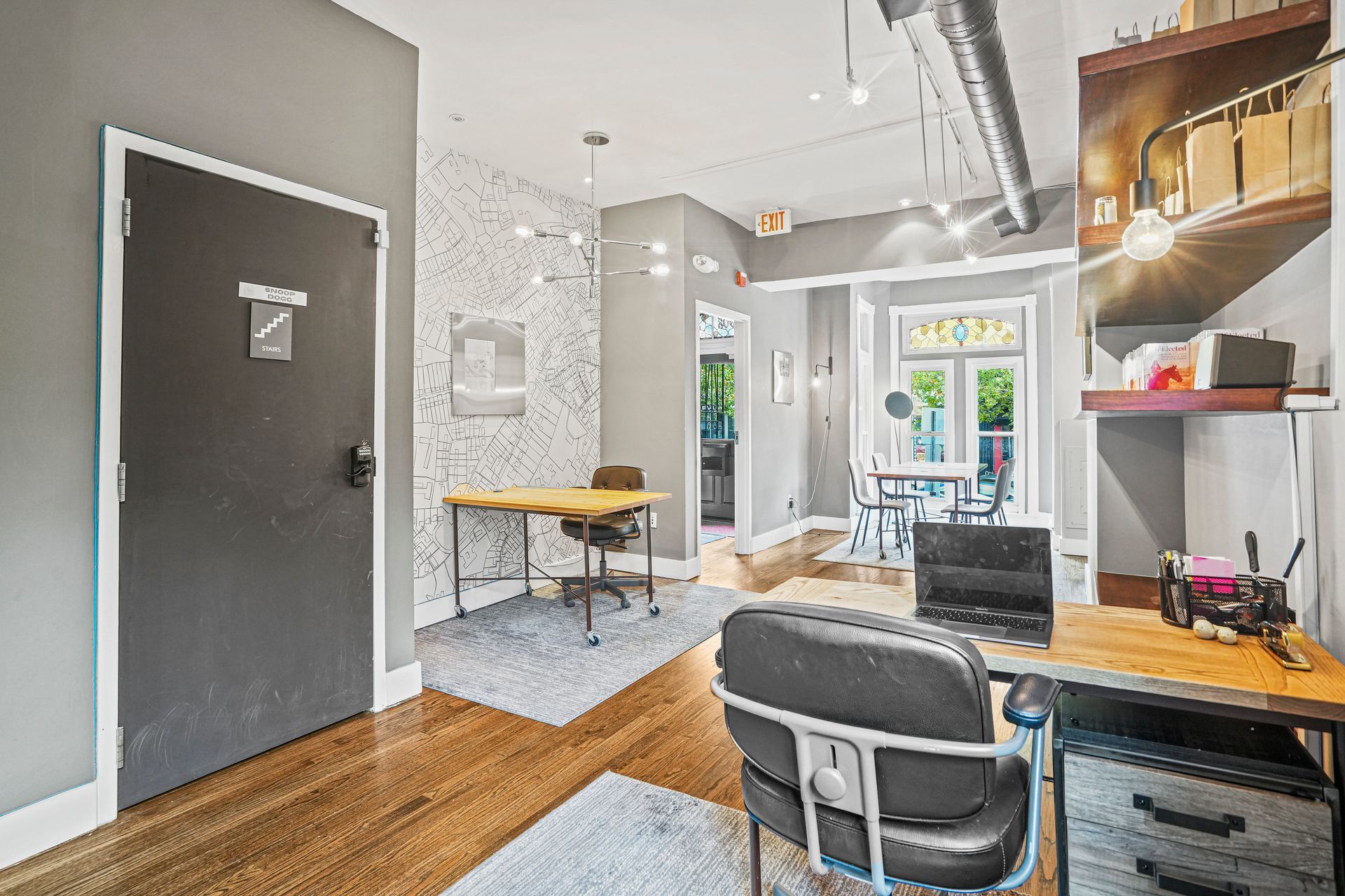 Open office floor plan with wood flooring and workstations