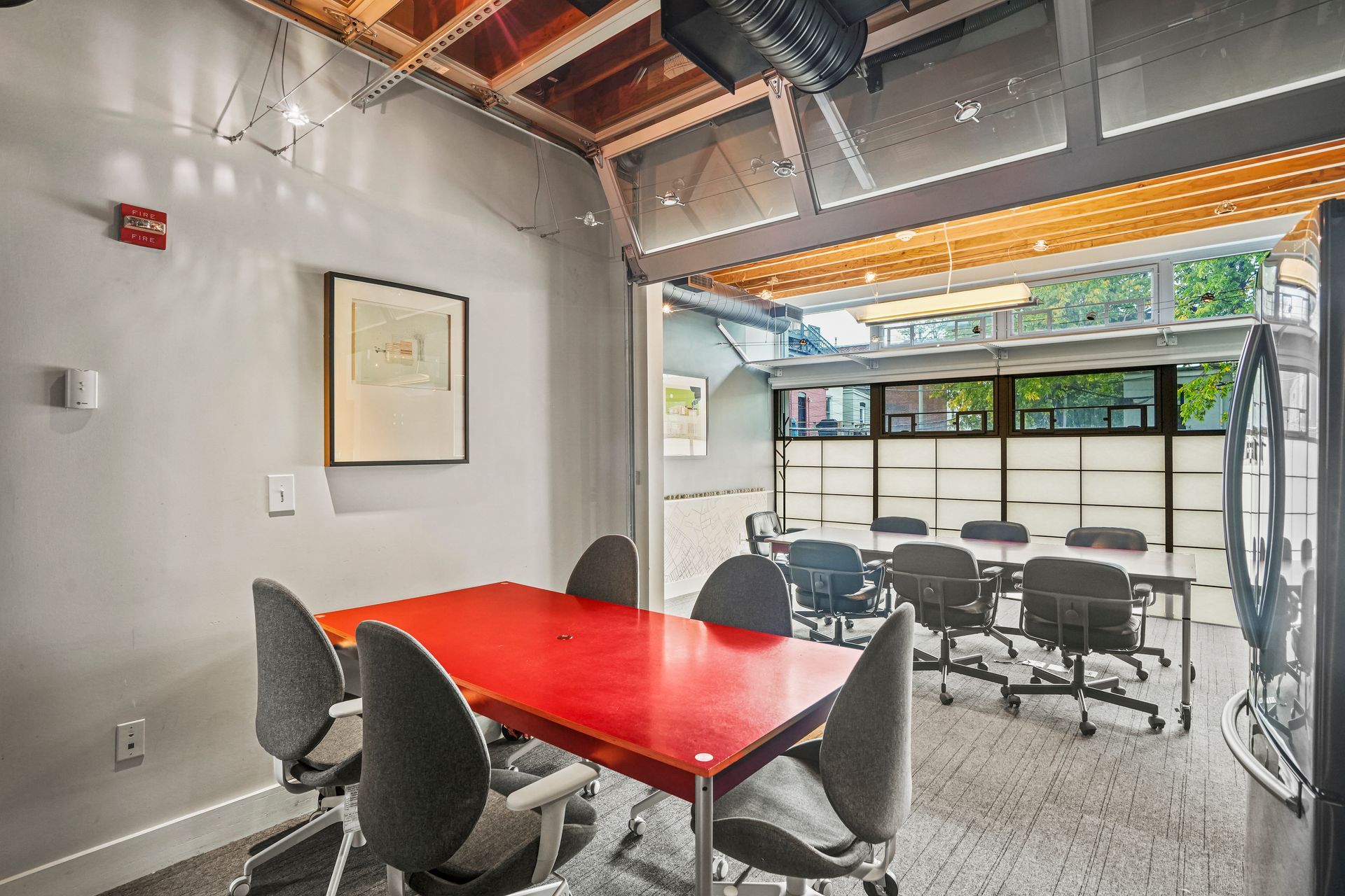 Meeting room with red conference table and office seating