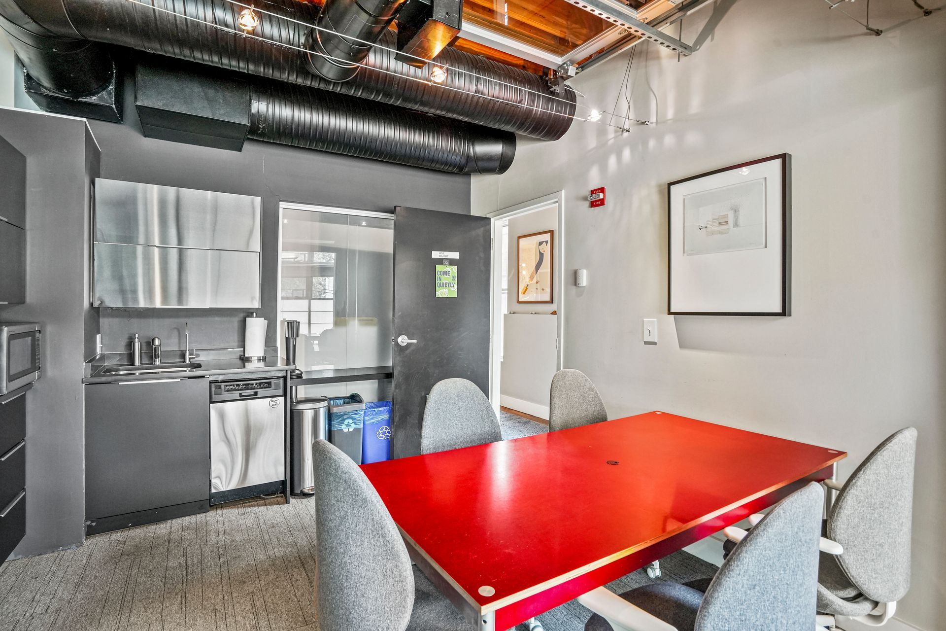 Conference room with red table and industrial office design