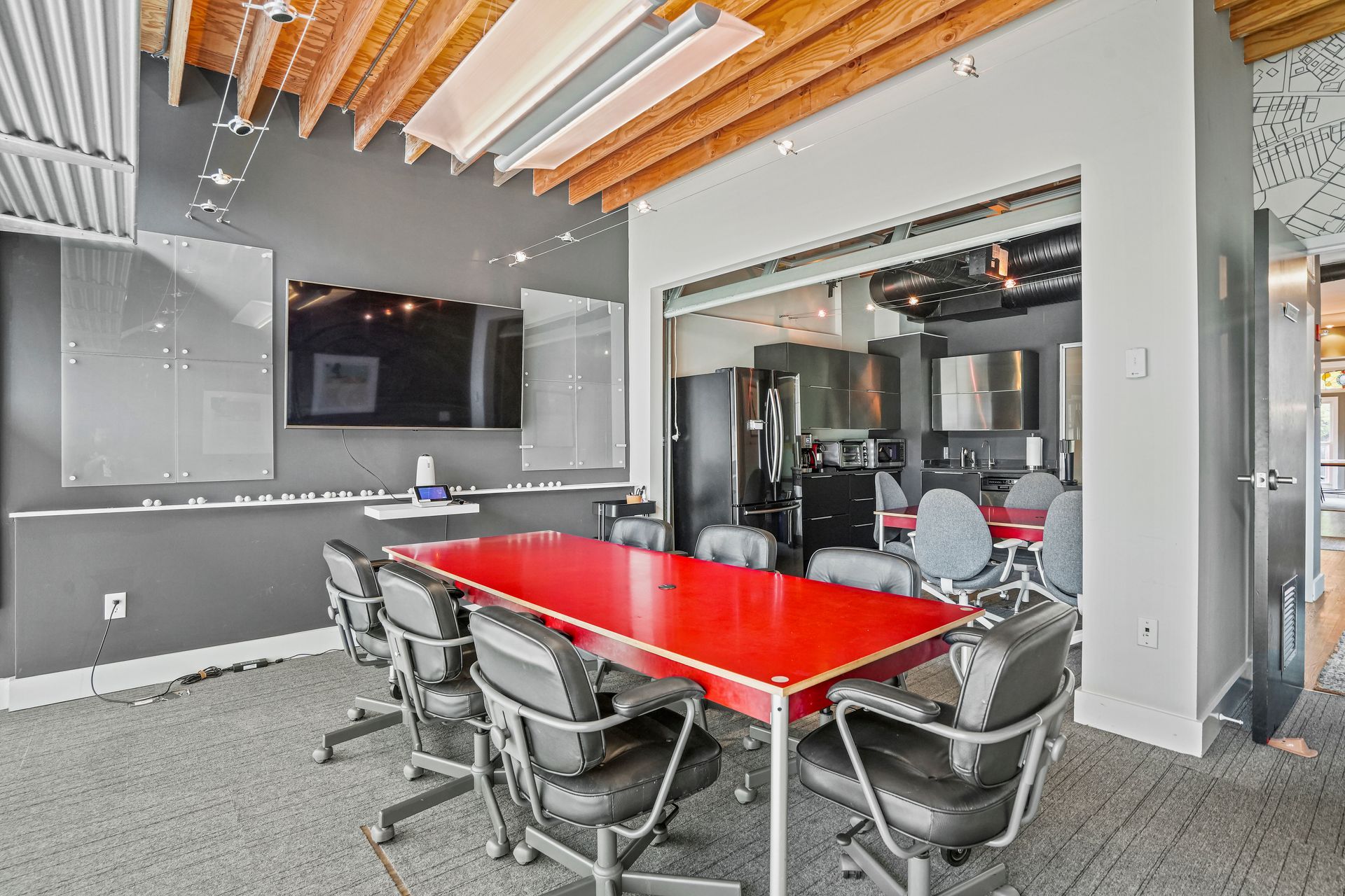 Open-plan office with kitchenette and collaborative workspace