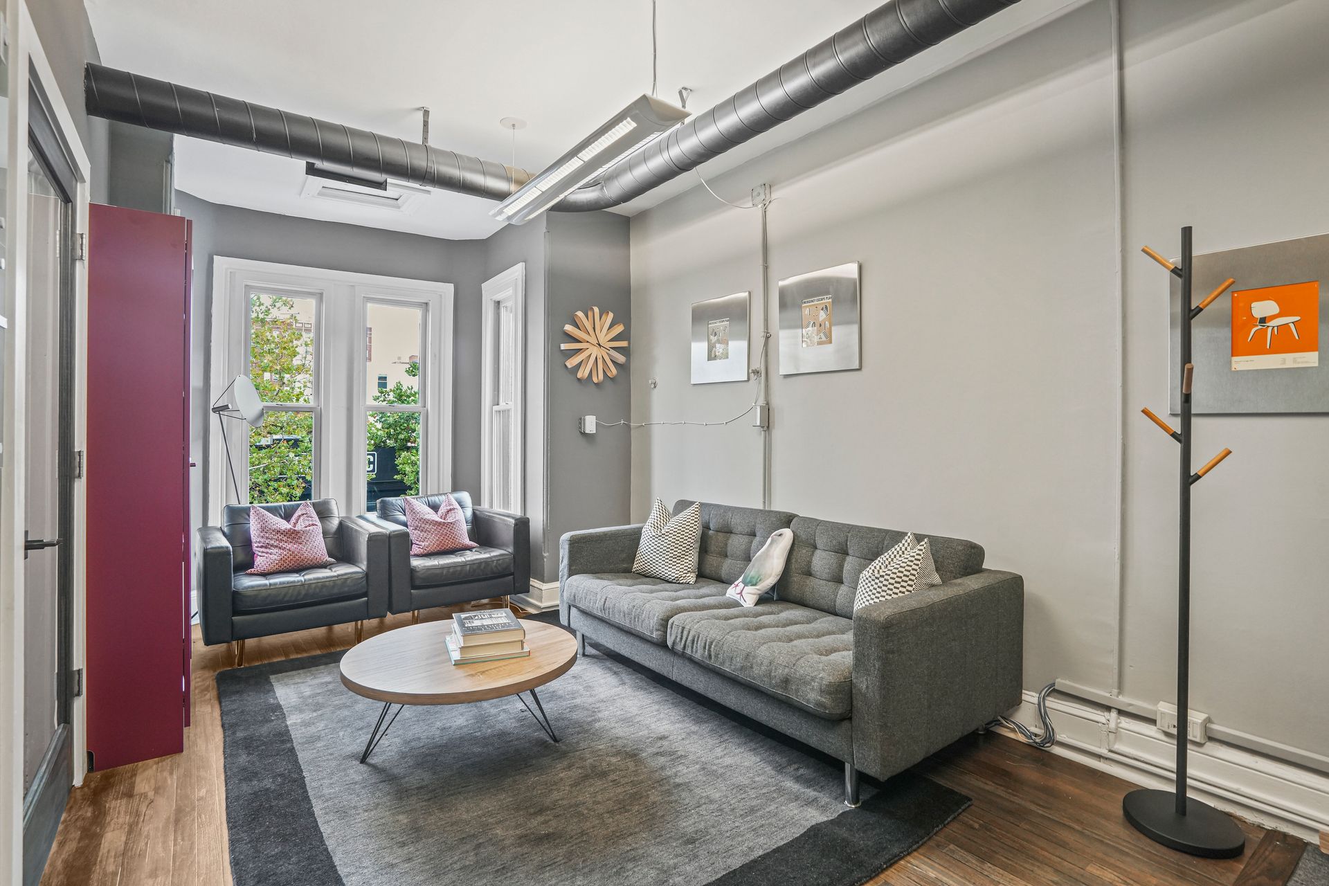 Comfortable office lounge with gray sofa and coffee table