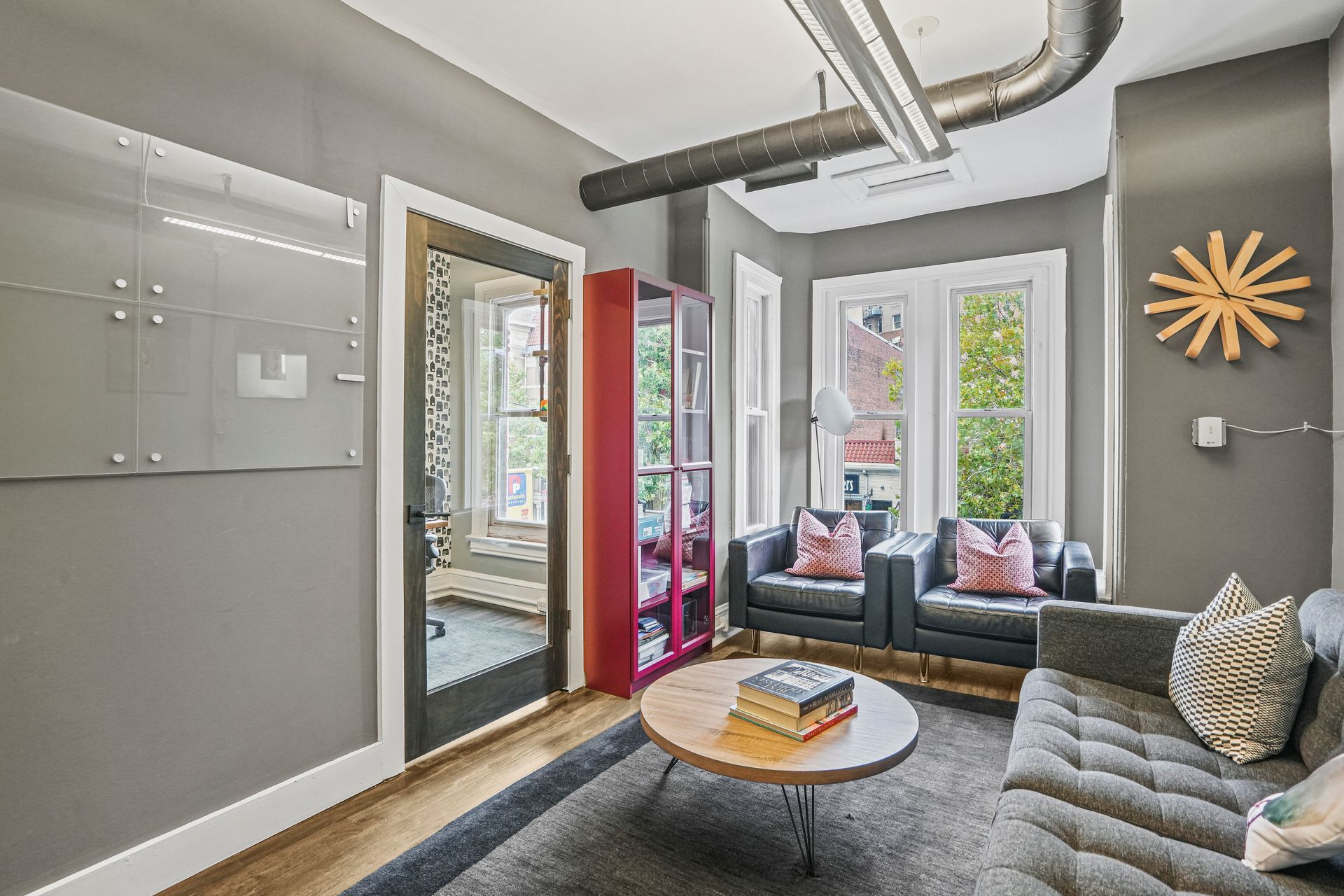 Bright lounge area with front-facing windows and seating
