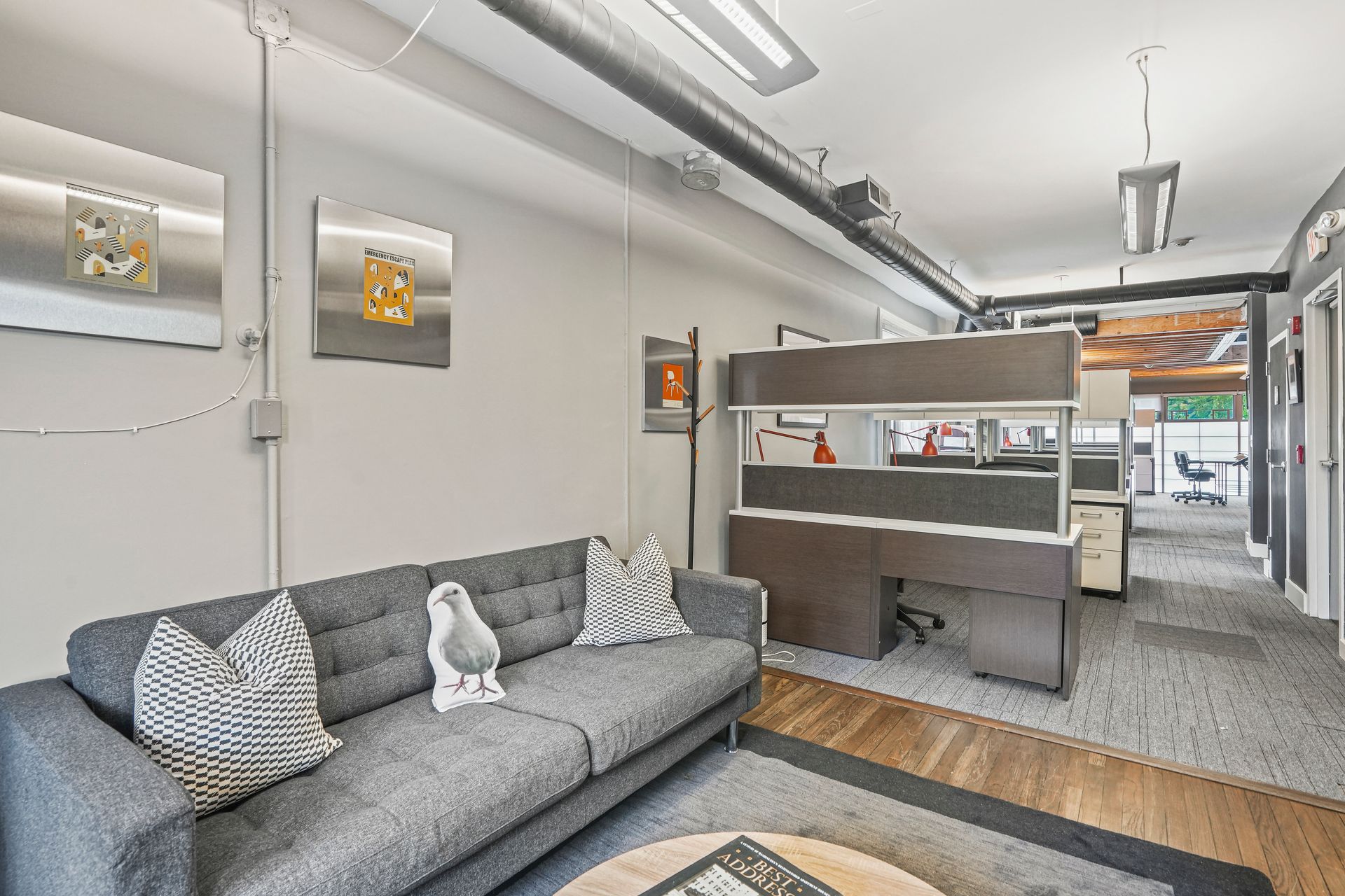 Modern lounge area with sofa and open office layout