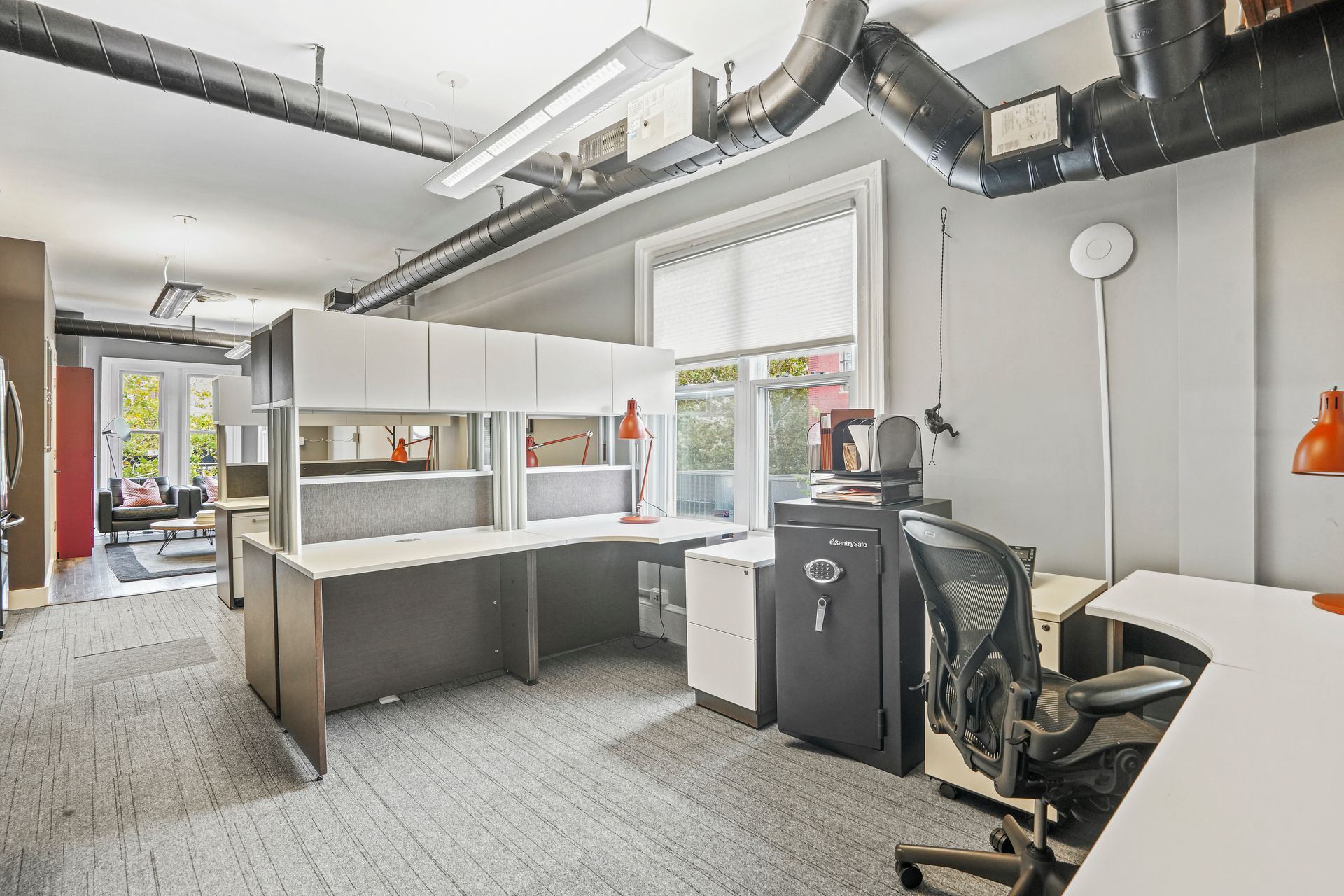 Open office area with desks and exposed wood ceiling beams