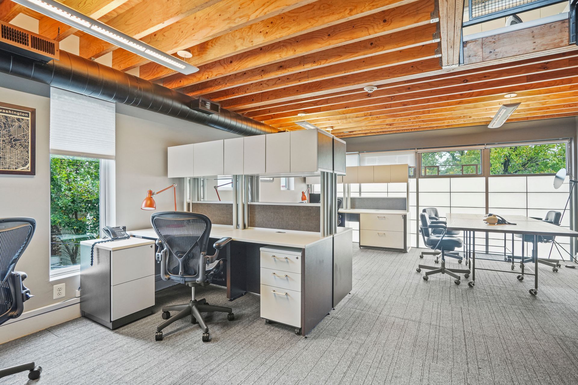 Spacious office workspace with cubicles and industrial design