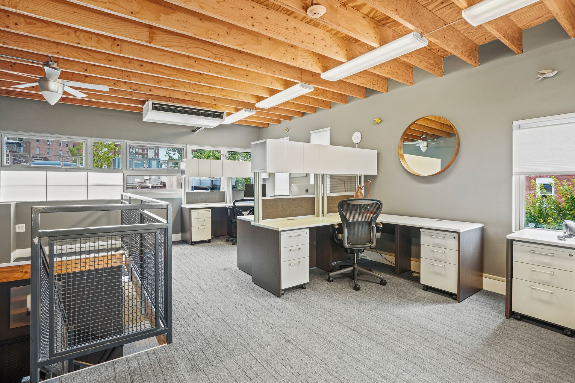 Collaborative workspace with industrial staircase and office desks
