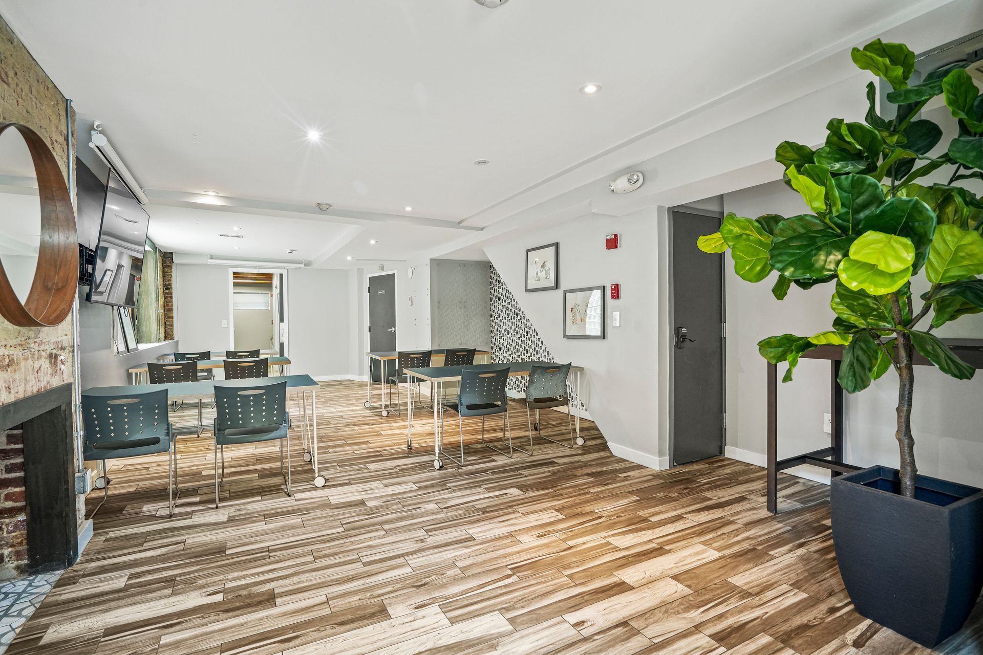 Spacious event space with fireplace and communal tables