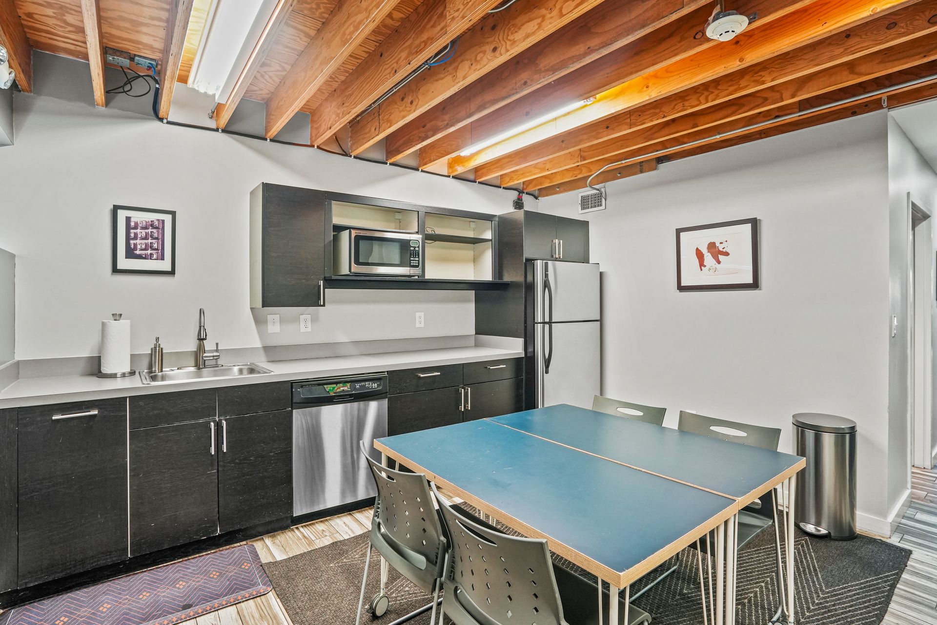 Break room with kitchenette and collaborative workspace seating