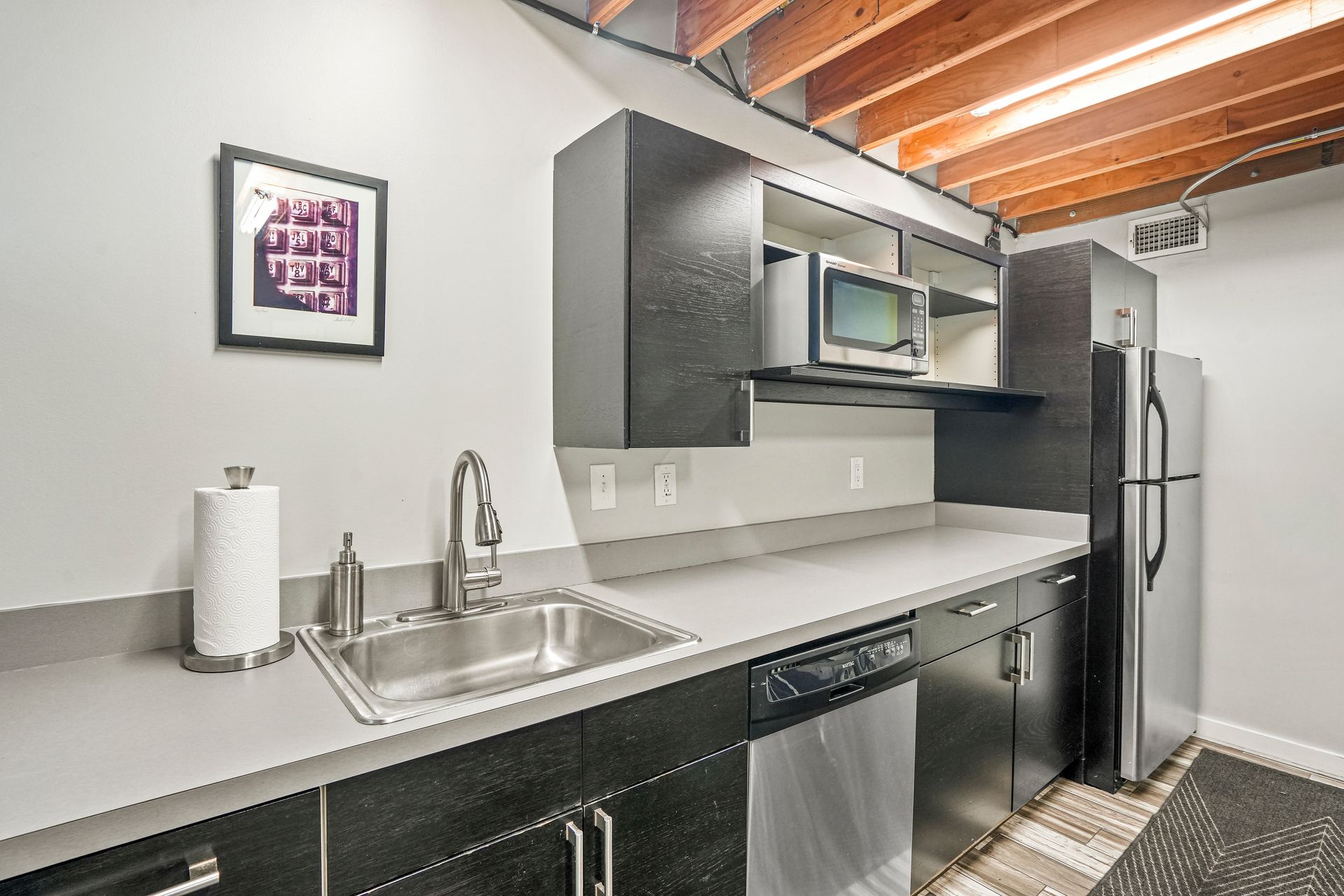 Contemporary kitchenette with sink and countertop workspace