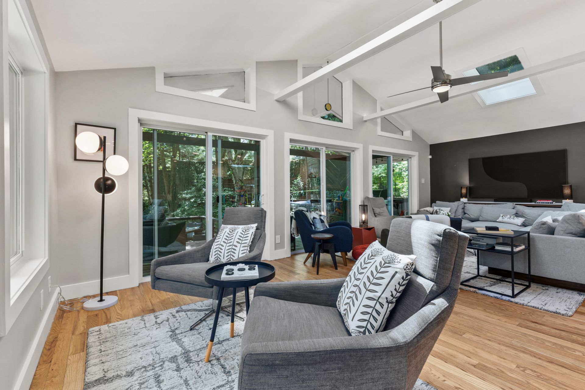 Open-concept living room with modern furnishings and fireplace