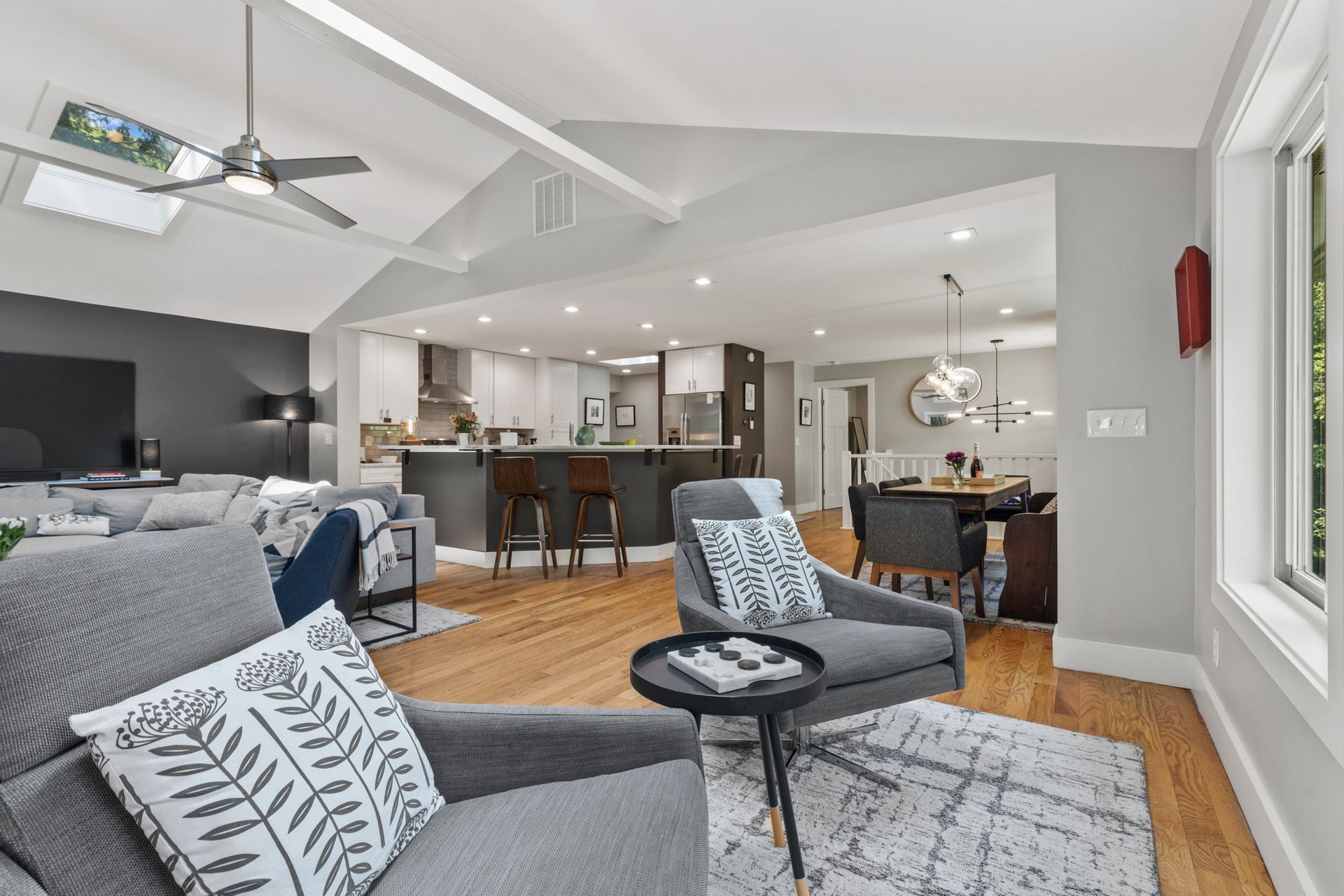 Modern living room with sectional sofa and kitchen view