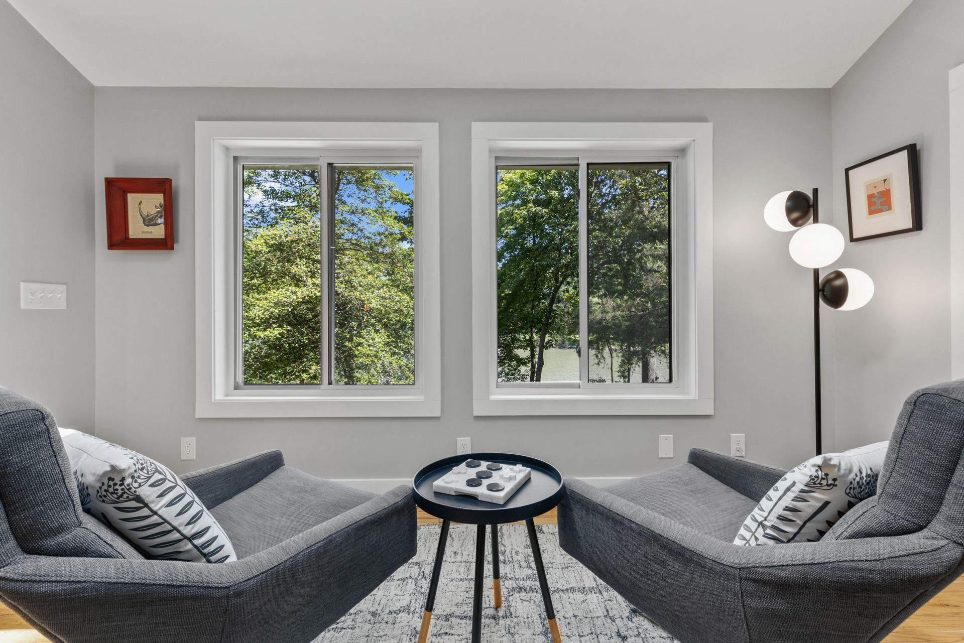 Modern bedroom with gray accent wall and large windows