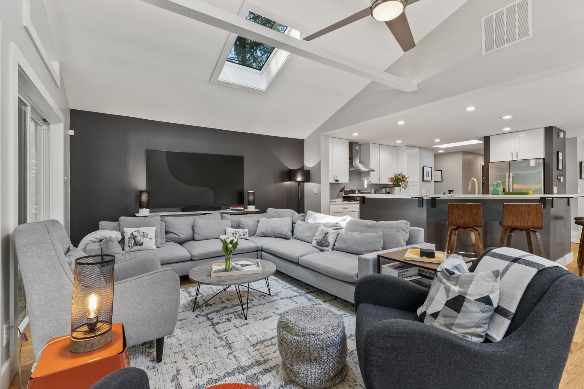 Modern living room with sectional sofa and kitchen view