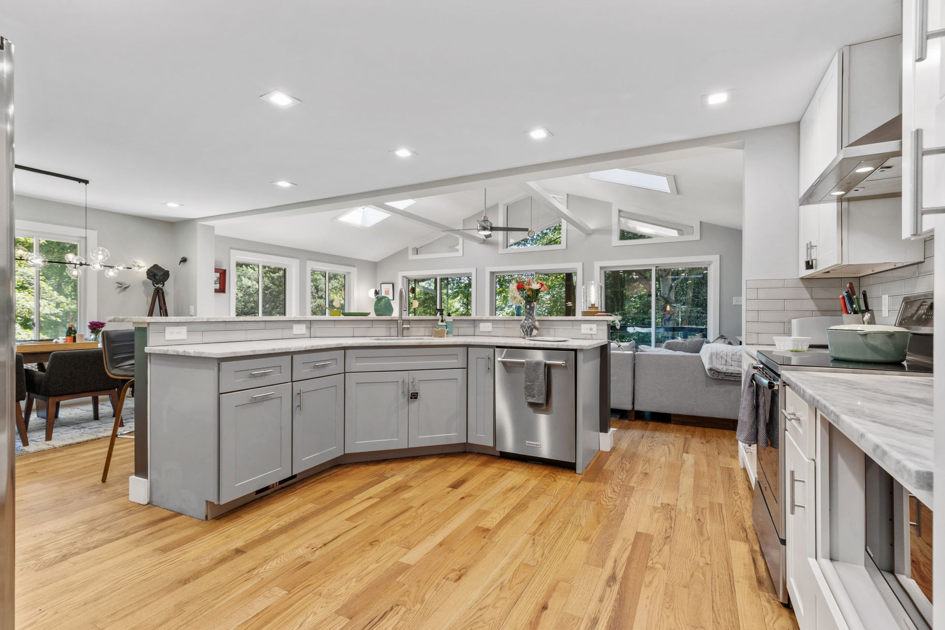 Open-concept kitchen and dining area with white cabinetry