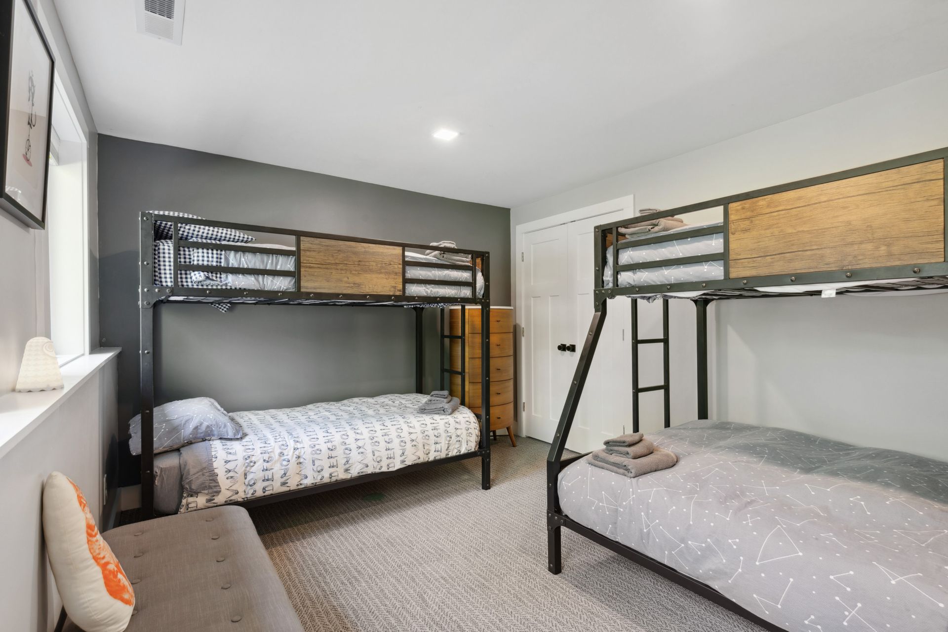 Modern bedroom with dark accent wall and built-in storage