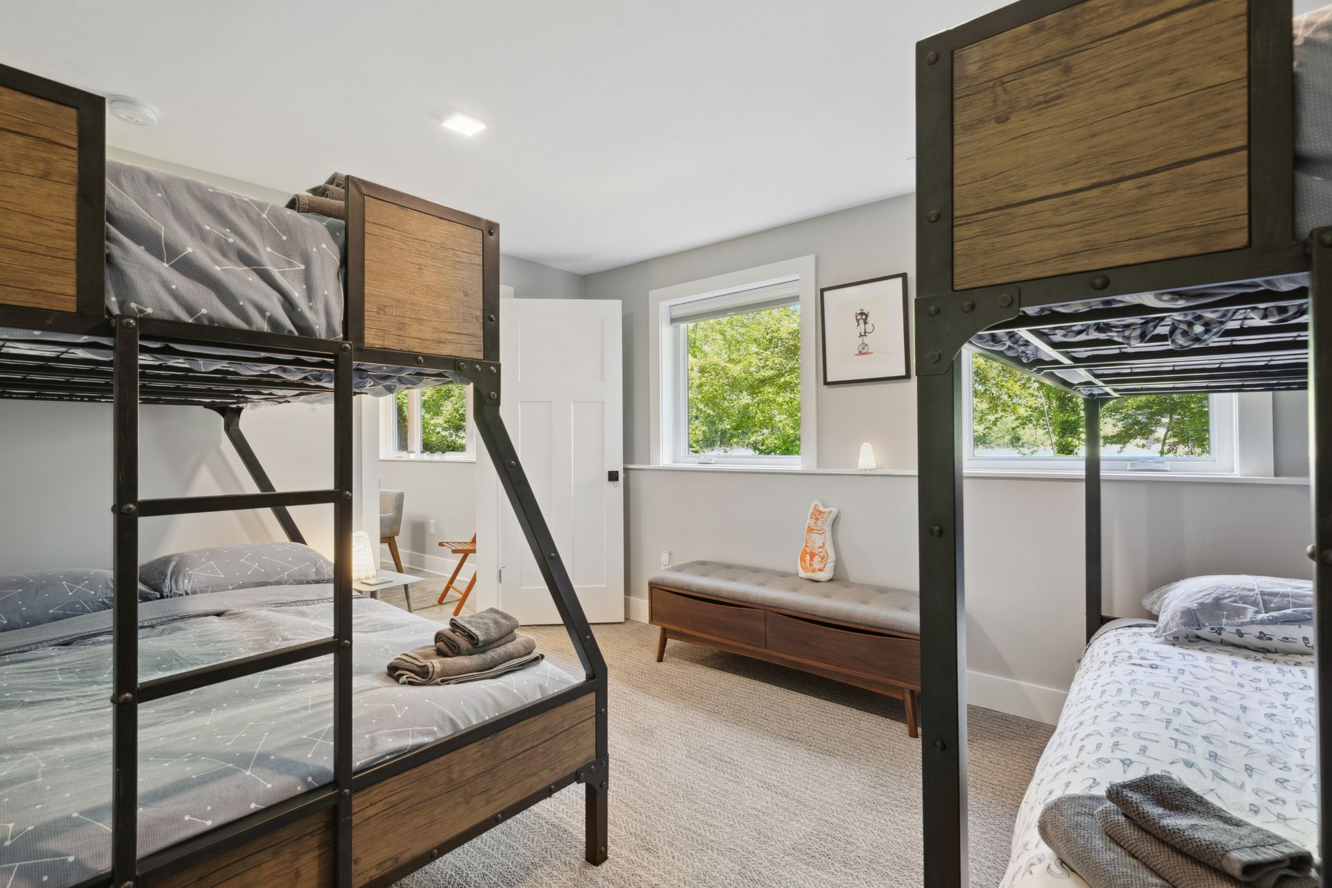 Modern bedroom with black metal accents and natural wood finishes