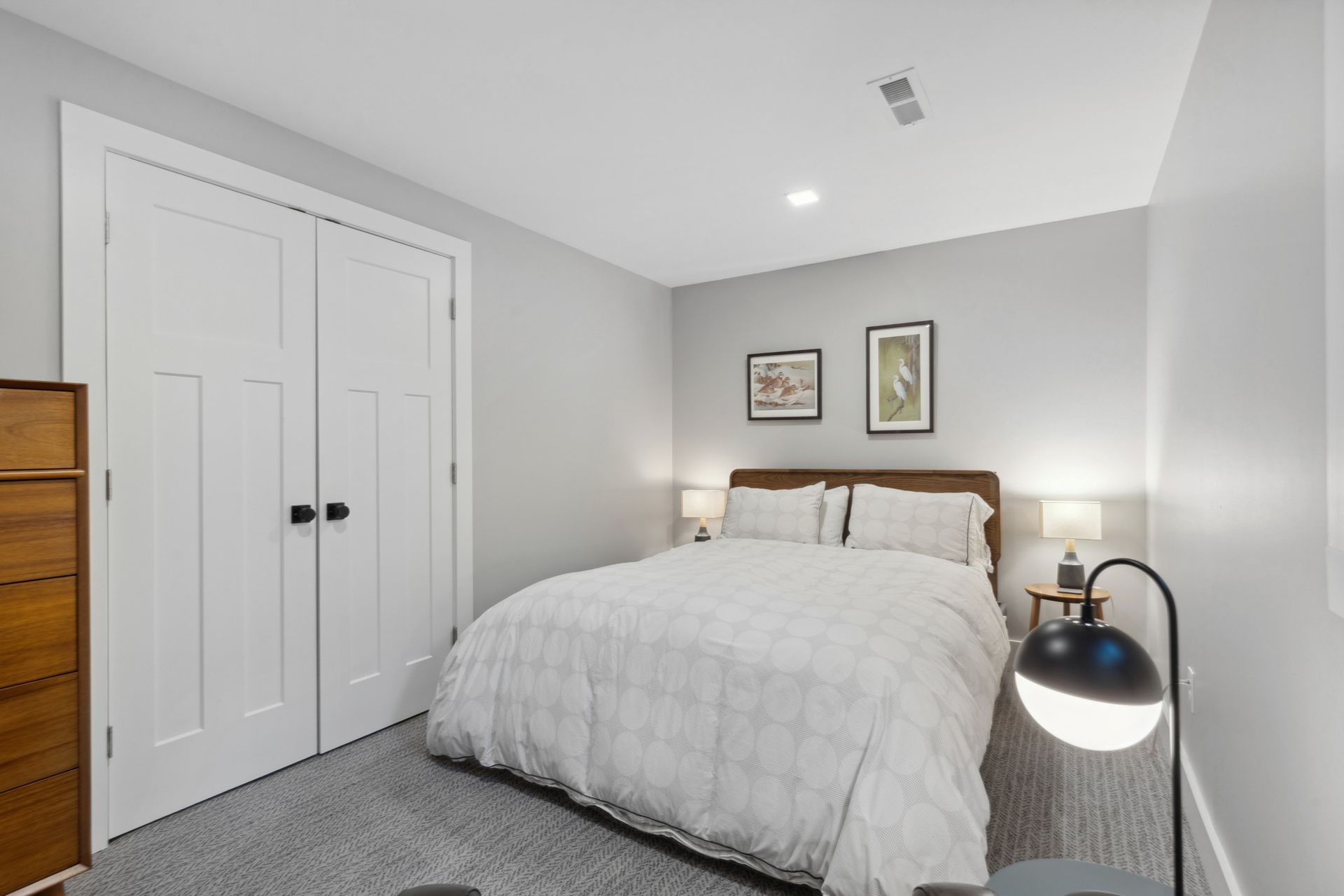 Minimalist bedroom with white bedding and modern furnishings