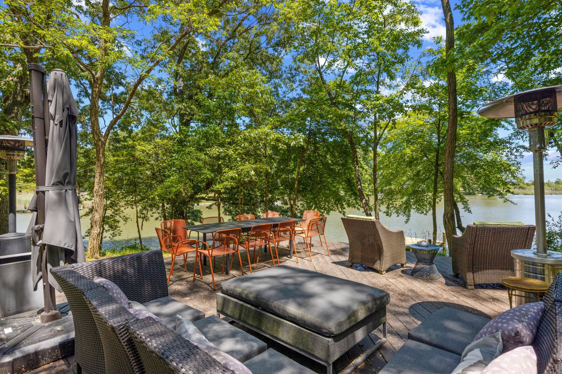 Outdoor patio lounge beneath mature trees