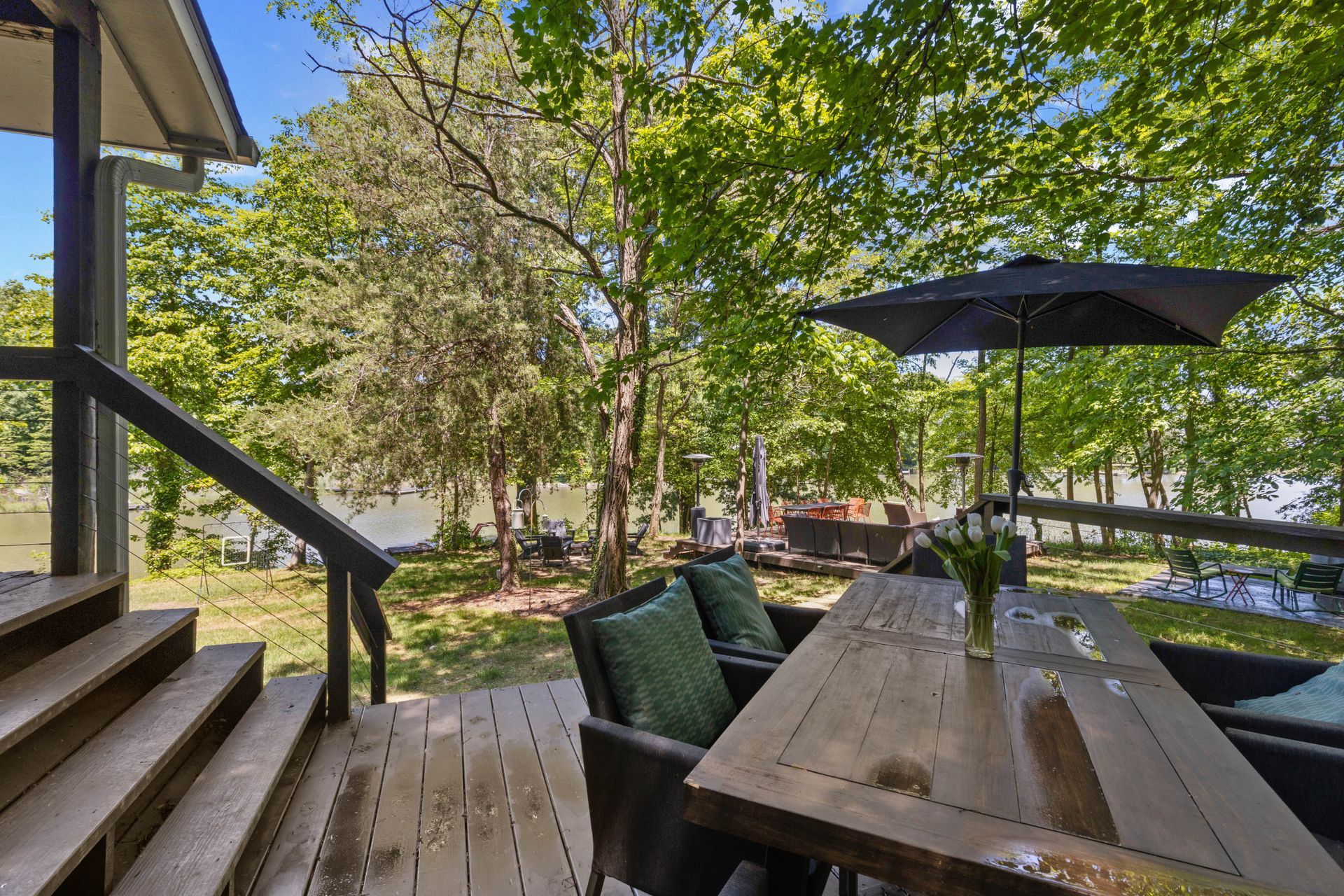 Outdoor deck surrounded by mature trees and greenery