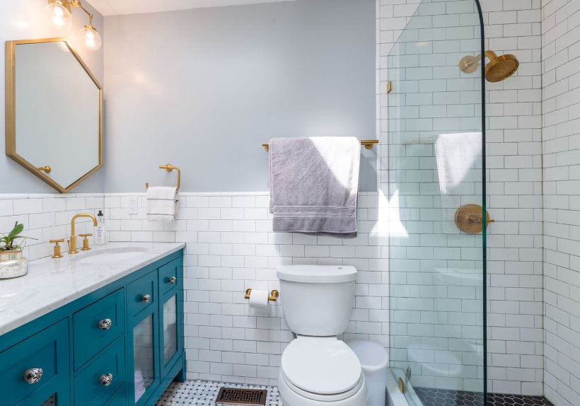 Bathroom with glass shower door and blue counter