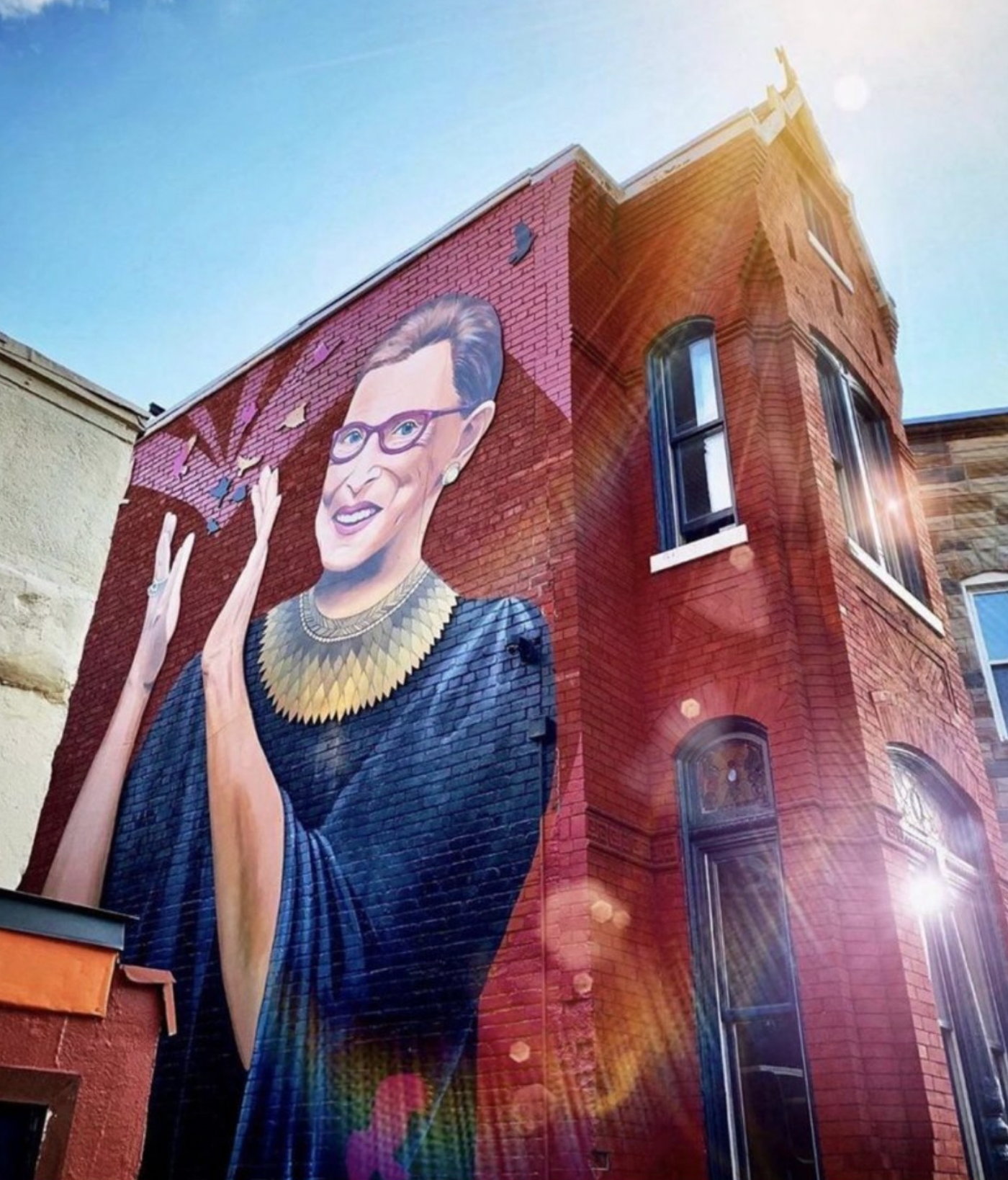 Large mural artwork on exterior brick wall