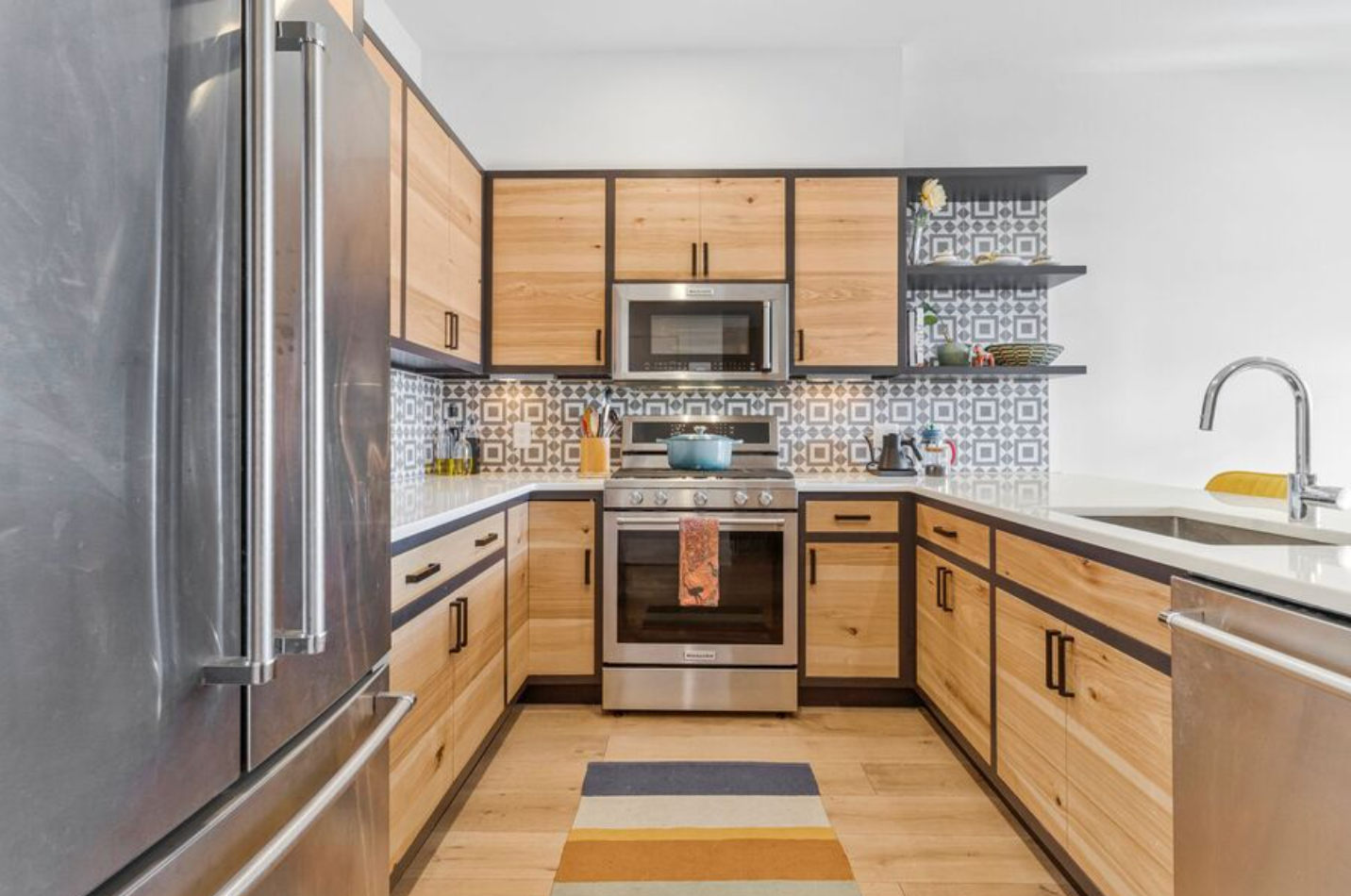 Bright apartment kitchen with island and cabinetry