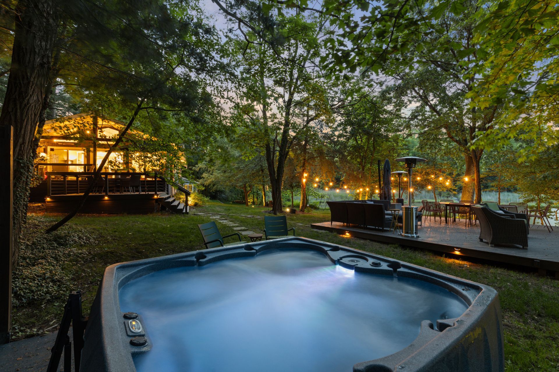 Outdoor patio with string lights and landscaped gathering space