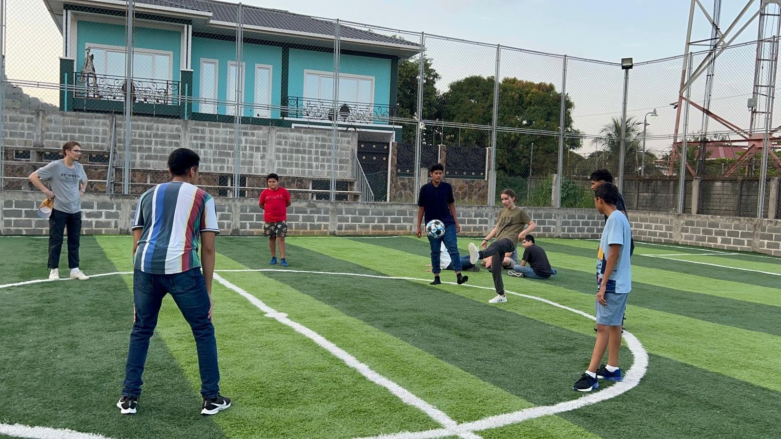 A group of people are playing soccer on a field.