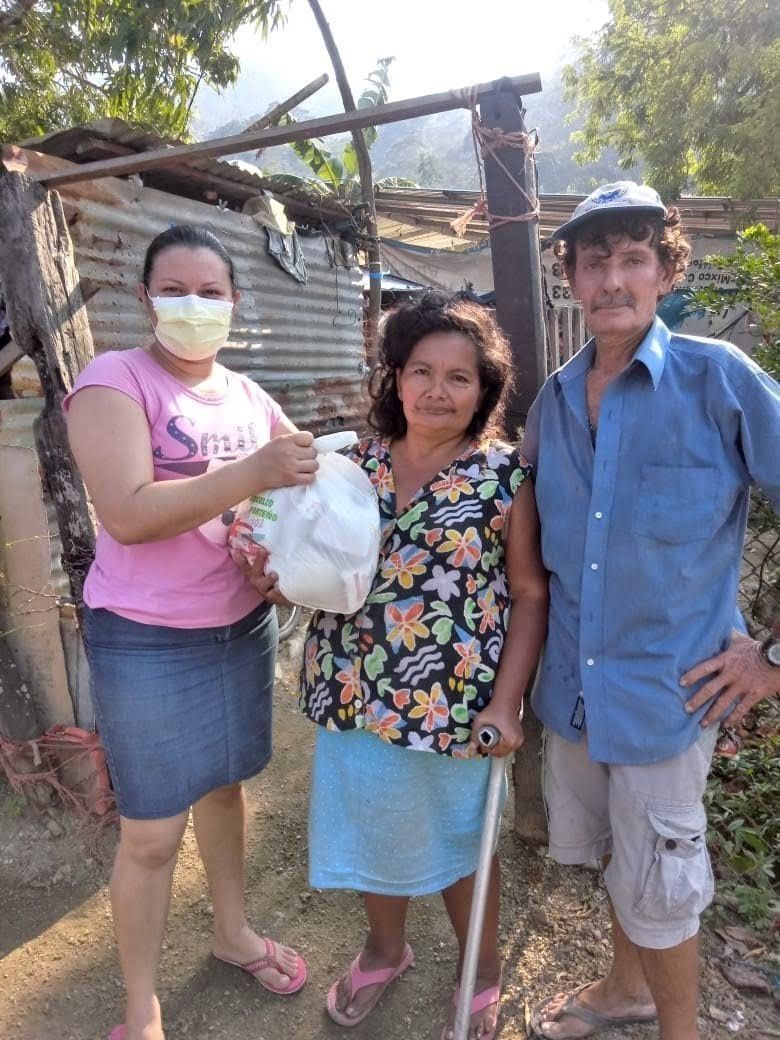 A man and two women are standing next to each other