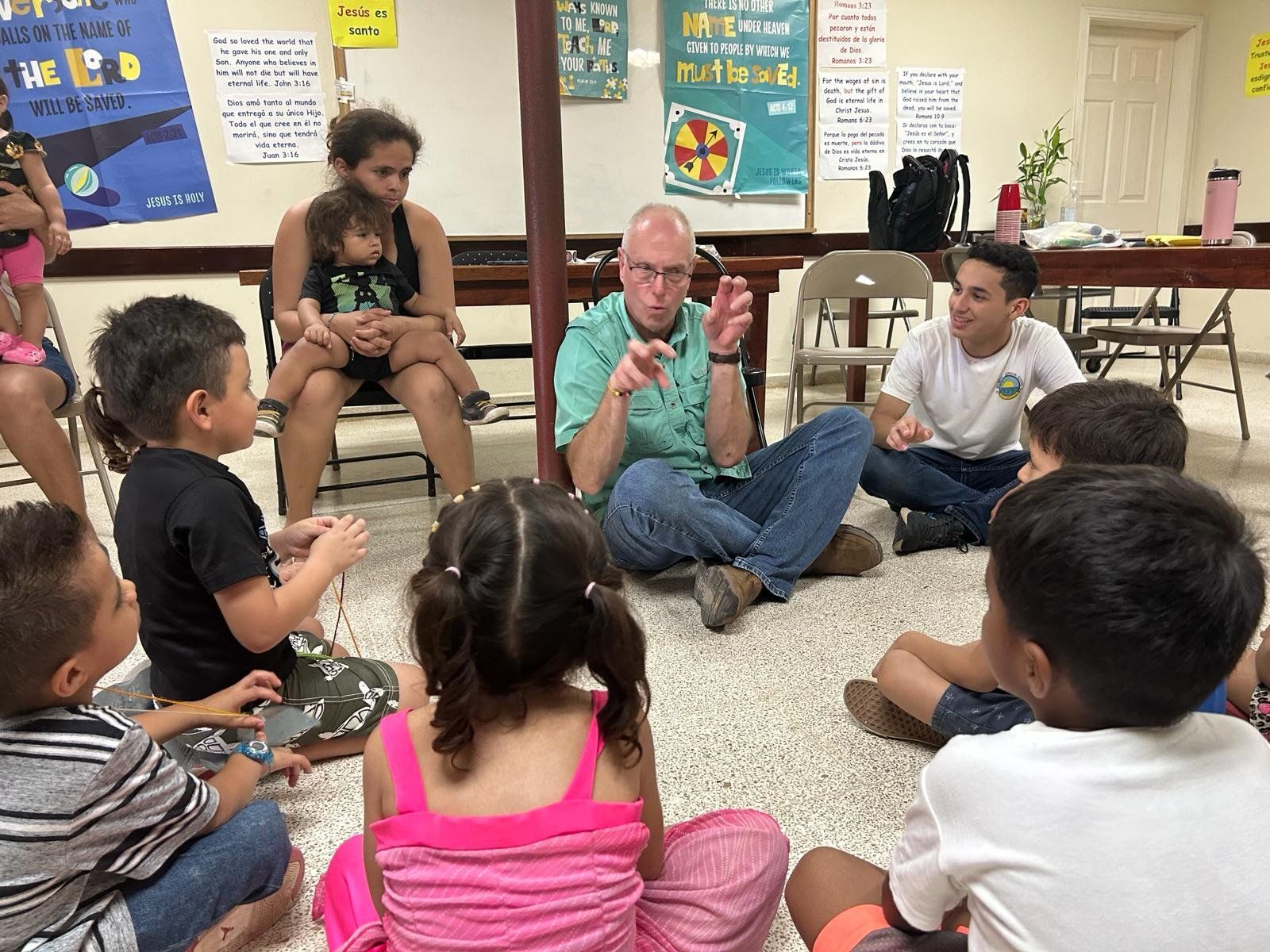 A group of people are sitting in a circle on the floor.