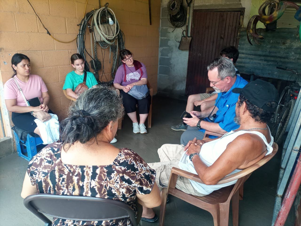 A group of people are sitting in a circle talking to each other