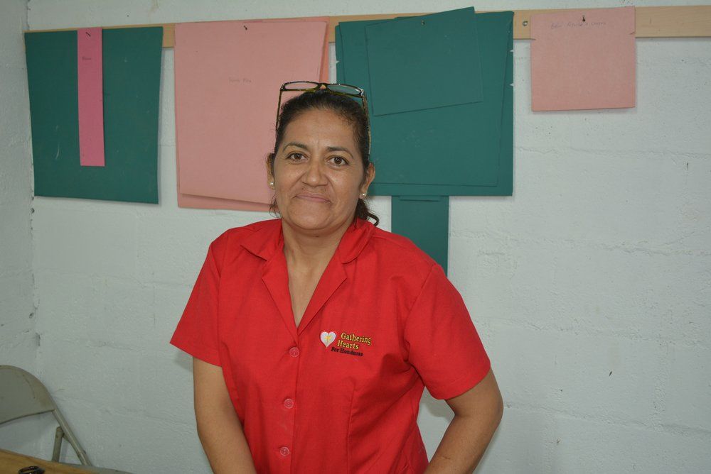 A woman in a red shirt with a heart on it