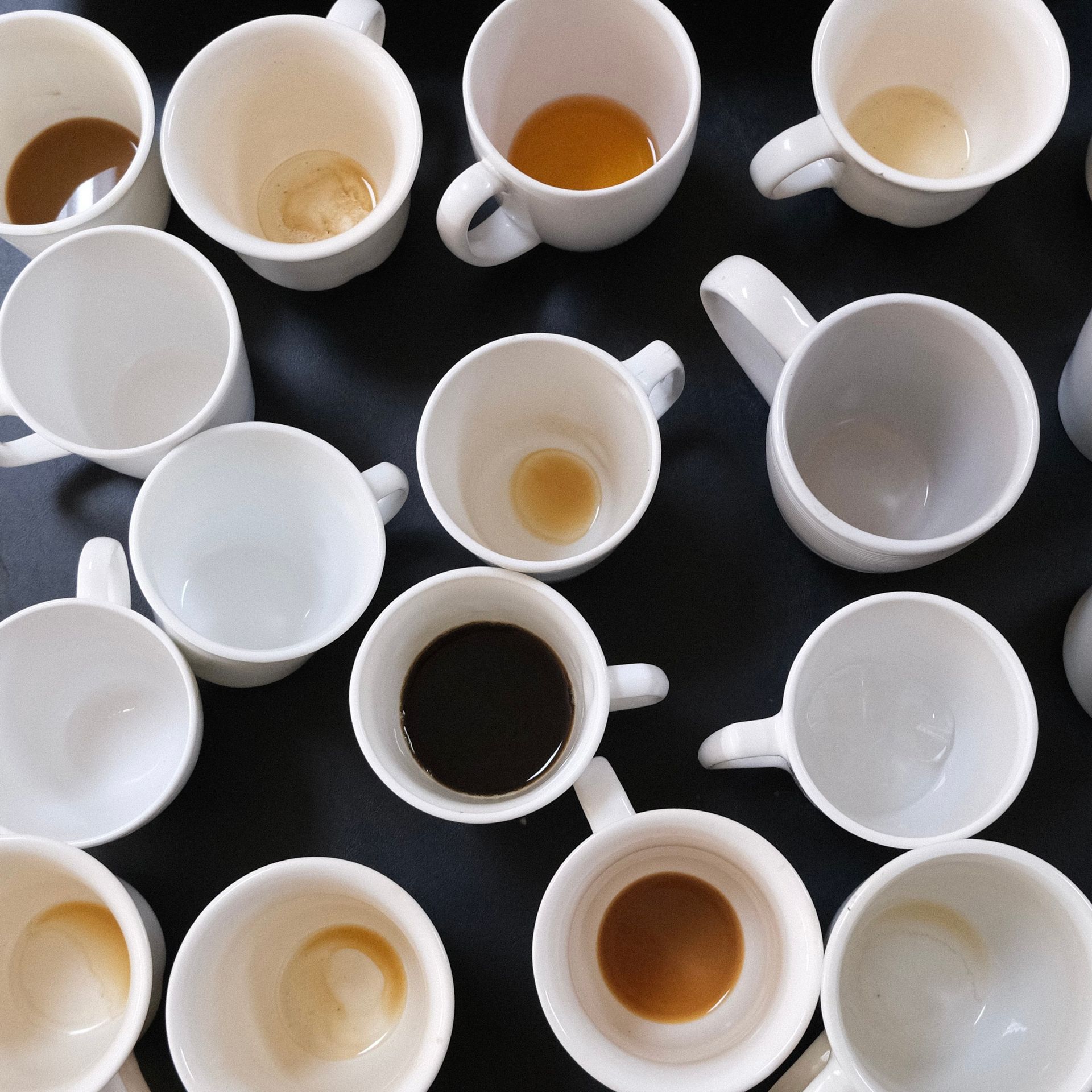 A bunch of coffee cups are sitting on a table