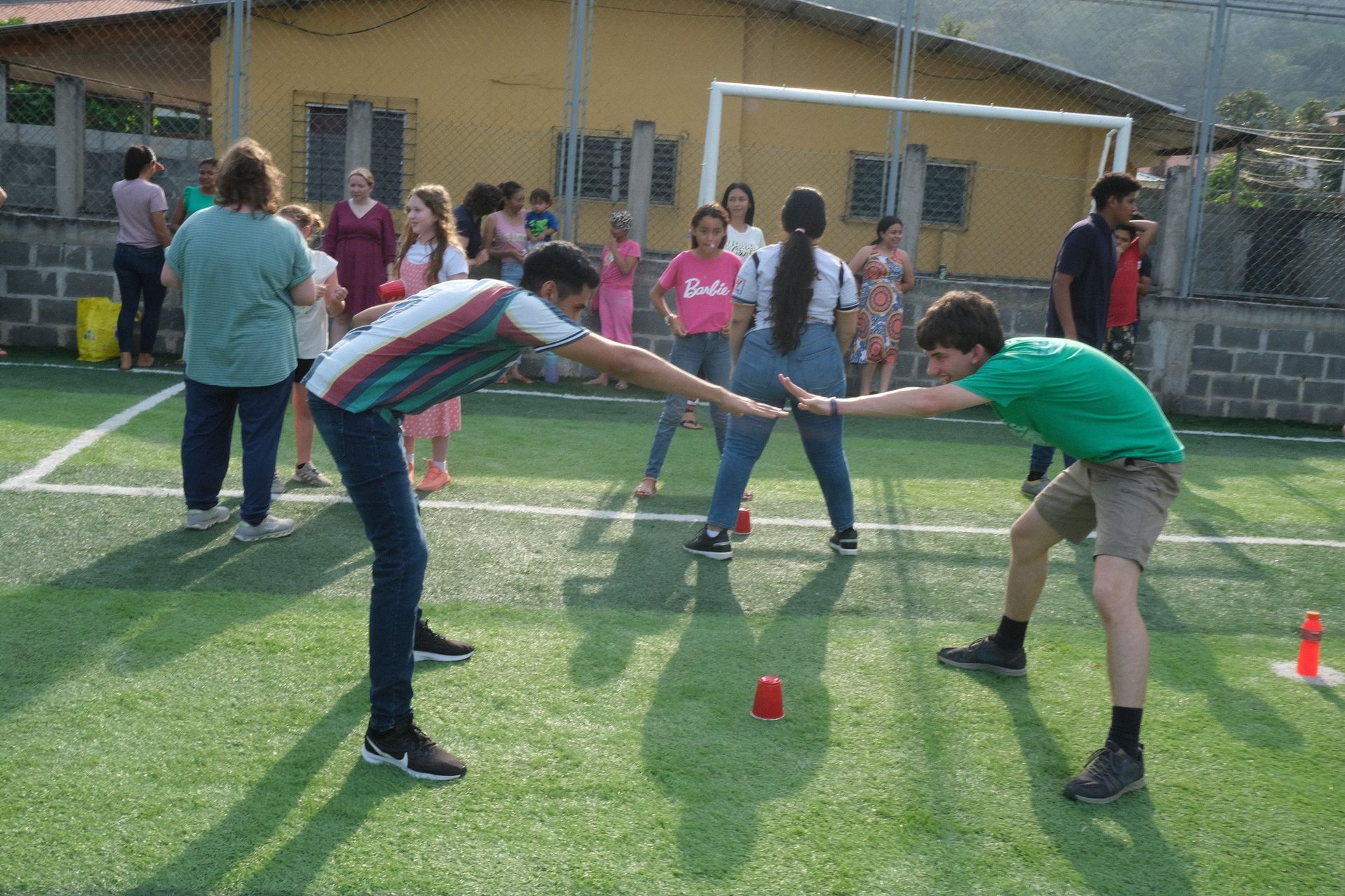A group of people are playing a game on a soccer field.