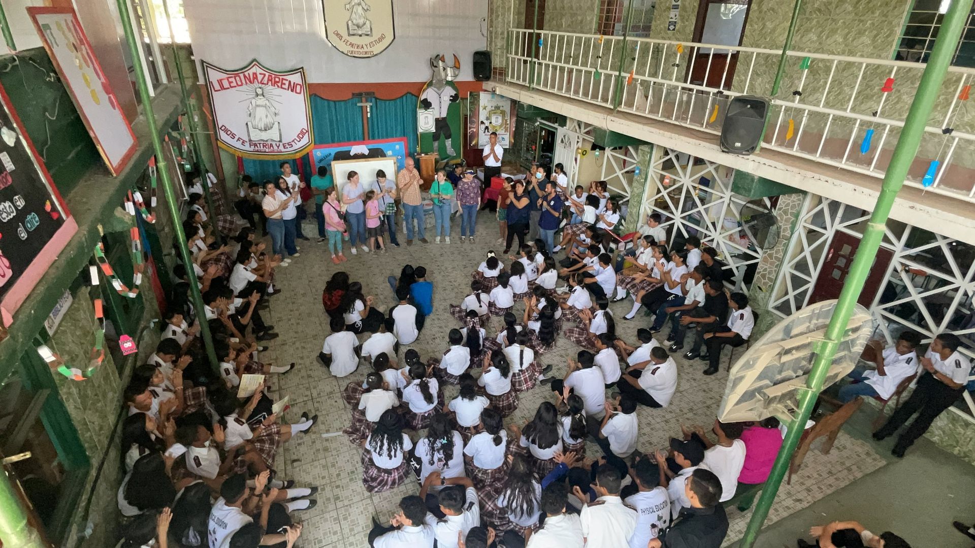 A group of people are sitting in a circle in a room.