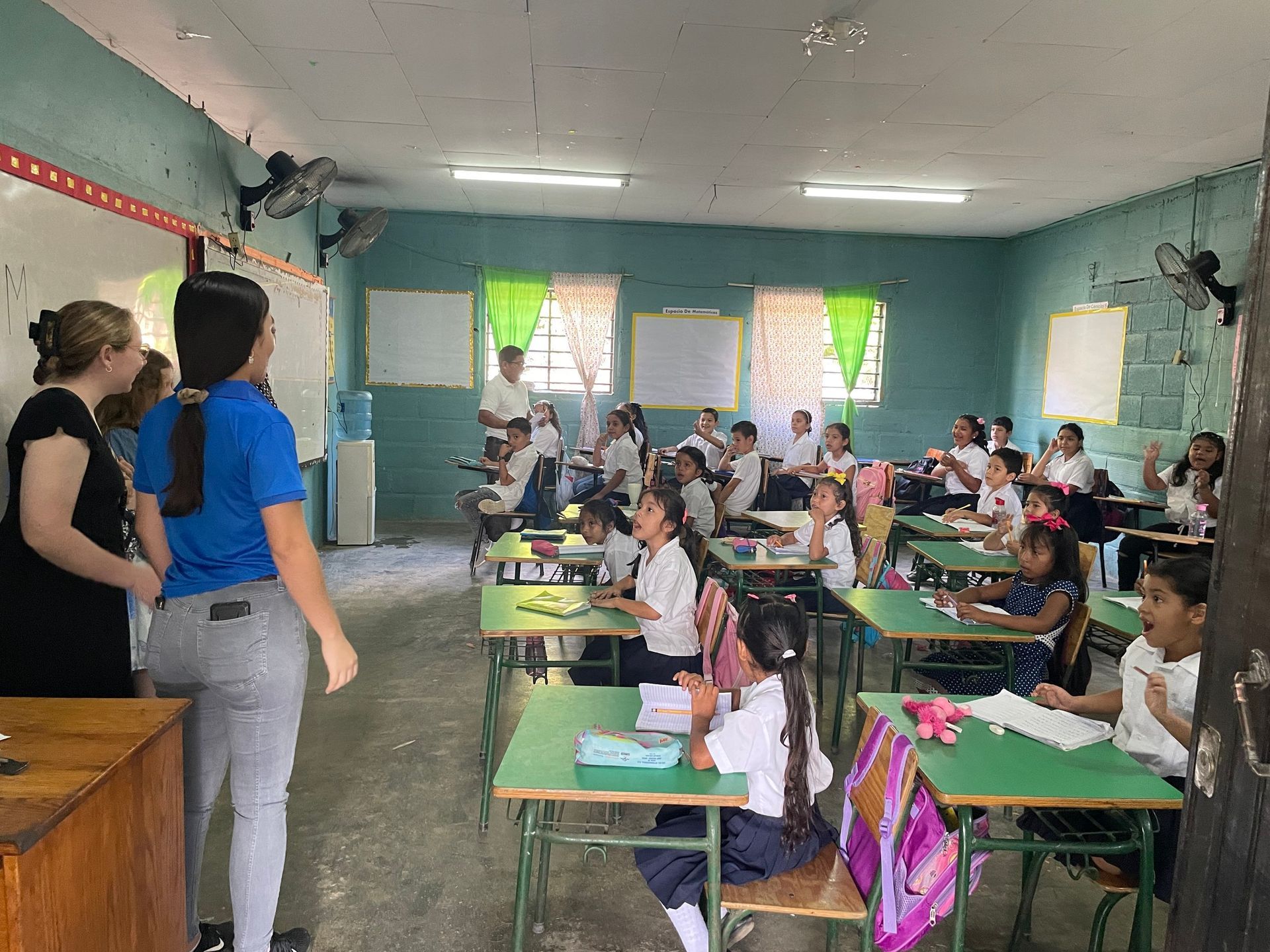 A group of children are sitting at desks in a classroom.