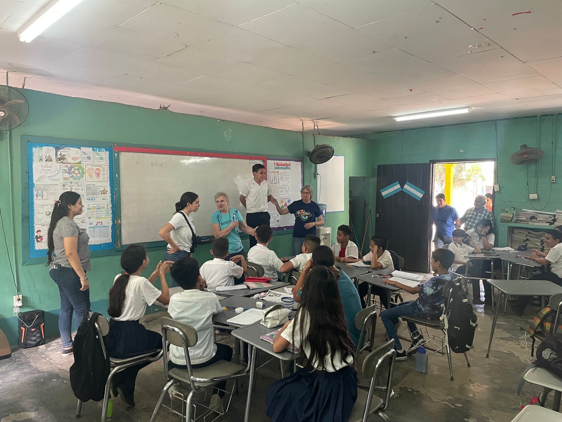 A group of children are sitting at desks in a classroom.